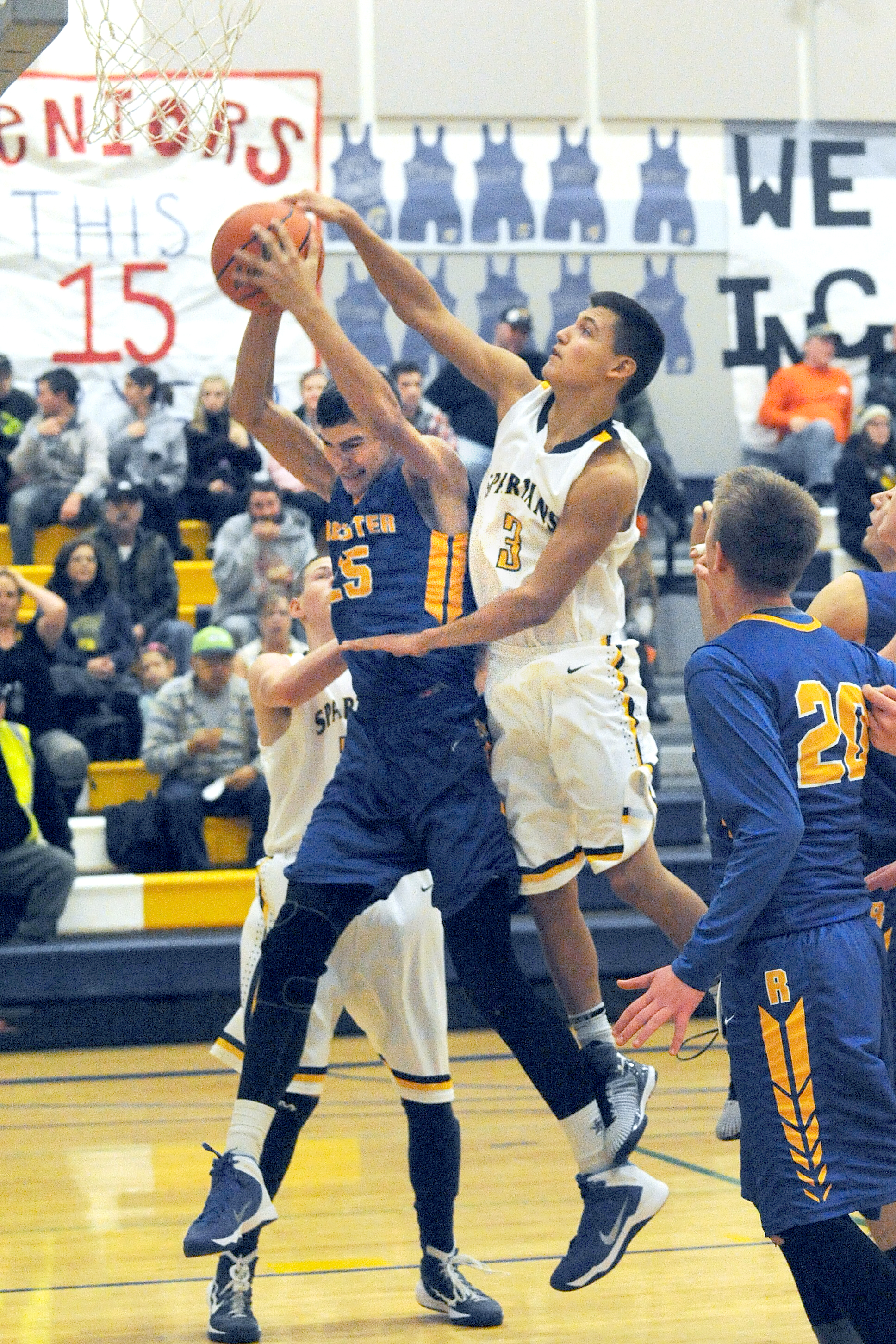 Forks' Keishaun Ramsey (3) challenges Rochester's Josh Kennedy (25) for the rebound Tuesday in Forks The Warriors defeated the Spartans 58-50. Lonnie Archibald/for Peninsula Daily News