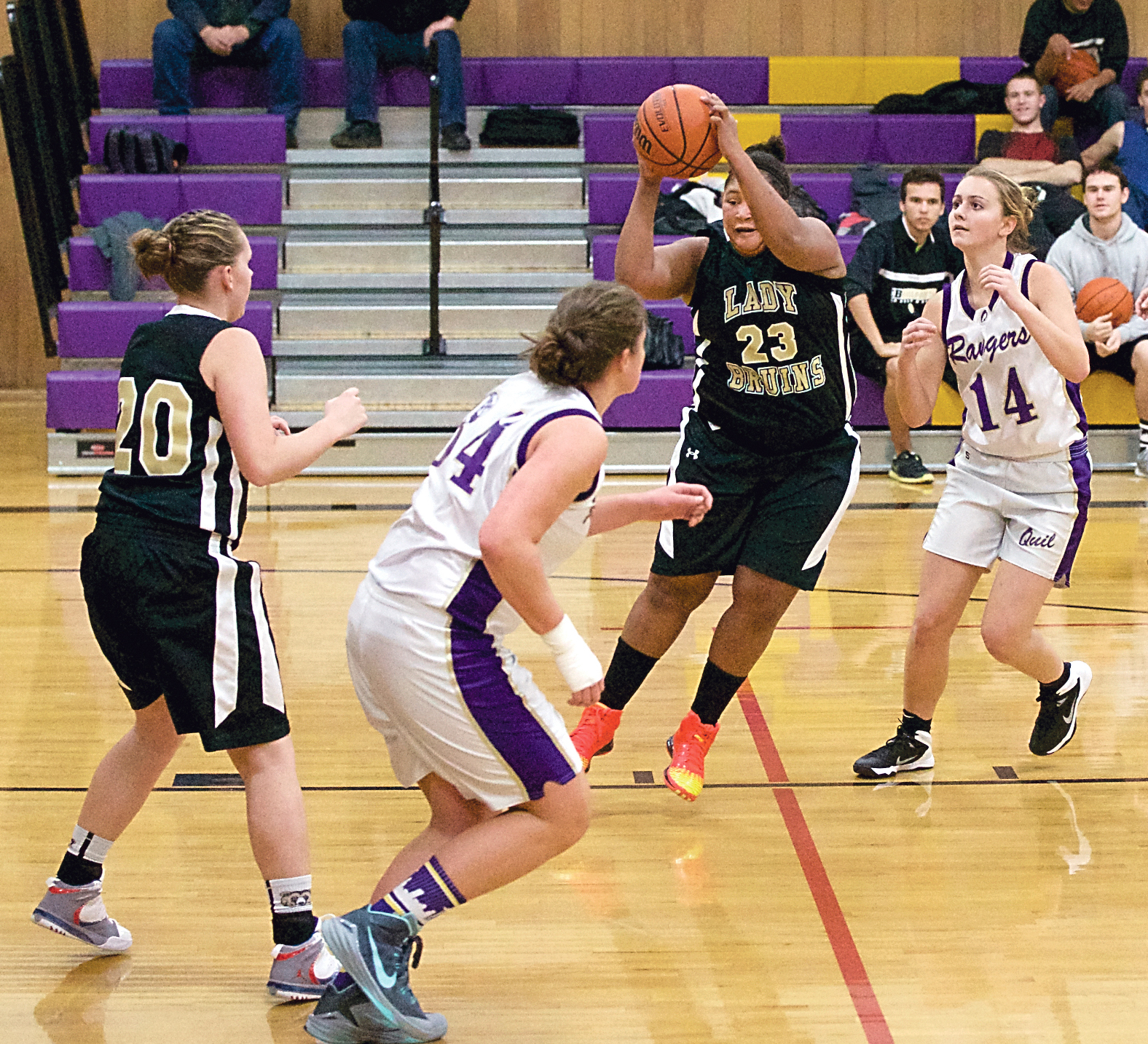 Clallam Bay's Zeria Signor (23) goes for the basket while being defended by Quilcene's Sammy Rae (34) and Katie Love (14)