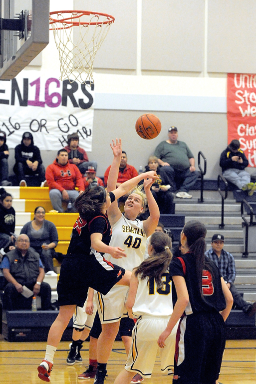 Forks' Alexis Leons (40) shoots over Neah Bay's Tristin Johnson (23) while the Spartans' Sage Barr (13) and the Red Devils' Jessica Greene (3) look on. Lonnie Archibald/for Peninsula Daily News