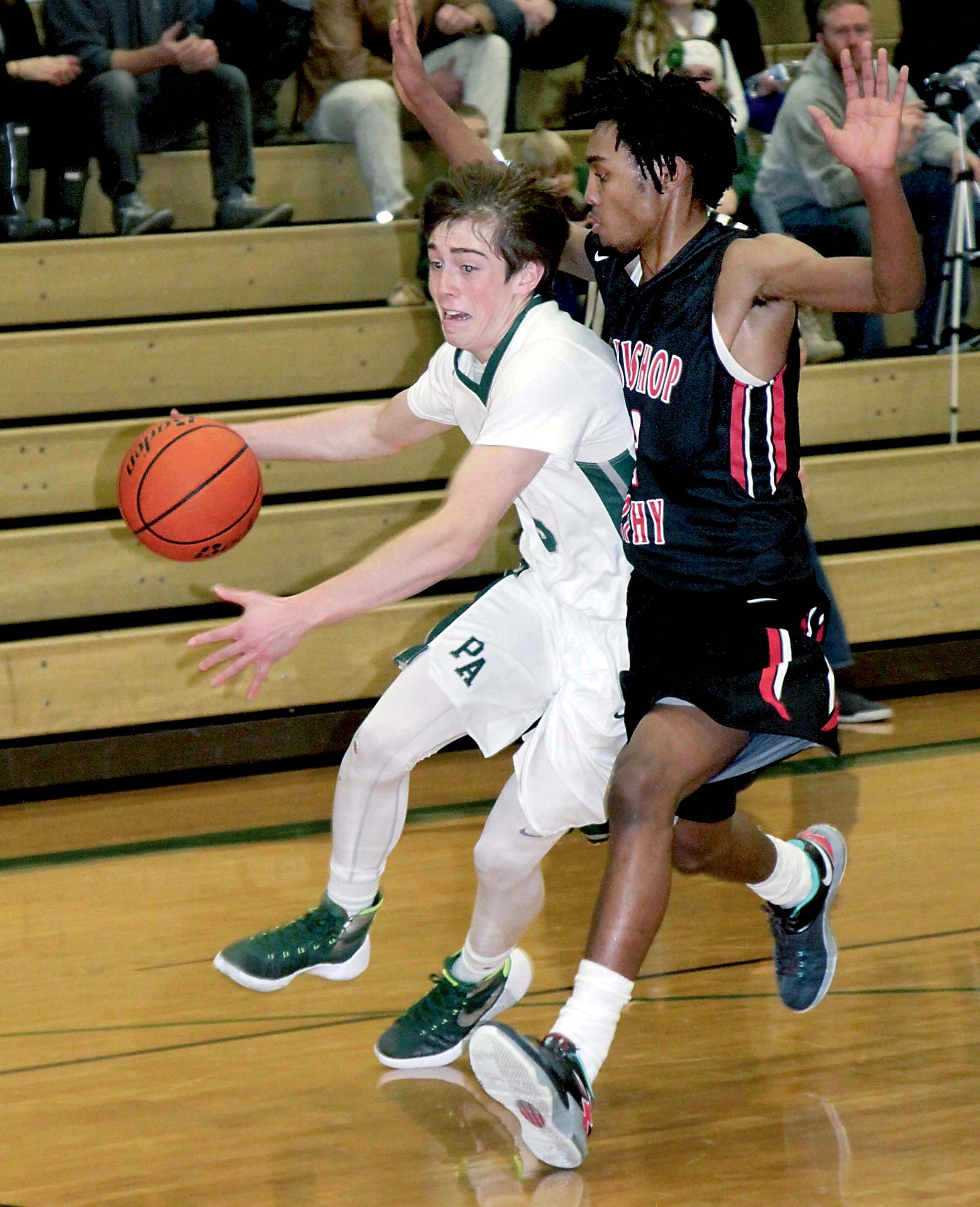 Port Angeles' Noah McGoff drives against Archbishop Murphy's Carson Truong during the first half of the Roughriders' 46-42 loss at Port Angeles High School. Dave Logan/for Peninsula Daily News