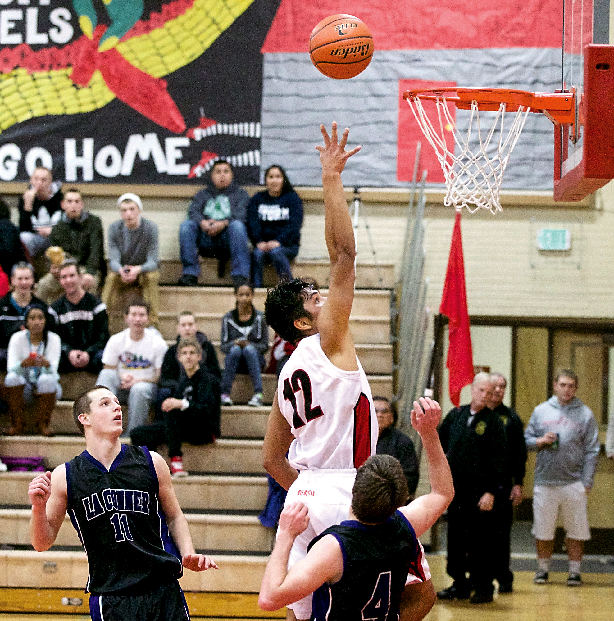 Neah Bay's Josiah Greene (12) makes the game-winning basket against La Conner at the Crush in the Slush tournament at Port Townsend High School. Steve Mullensky/for Peninsula Daily News