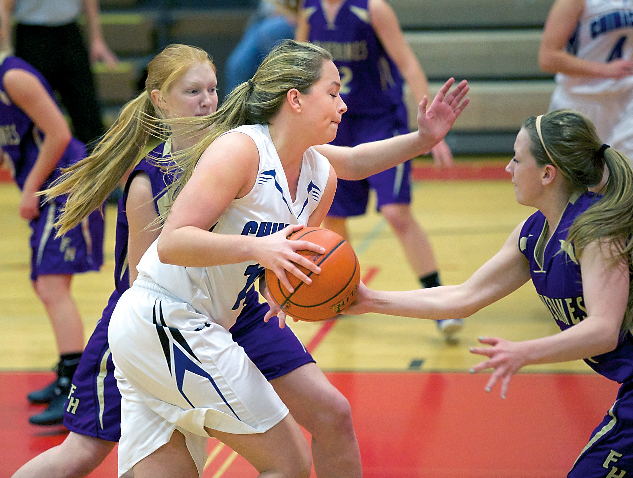 Chimacum's Lauren Thacker blasts through the defense of Friday Harbor's Taylor Turnbull during the opening game of the Crush in the Slush tournament. Steve Mullensky/for Peninsula Daily News