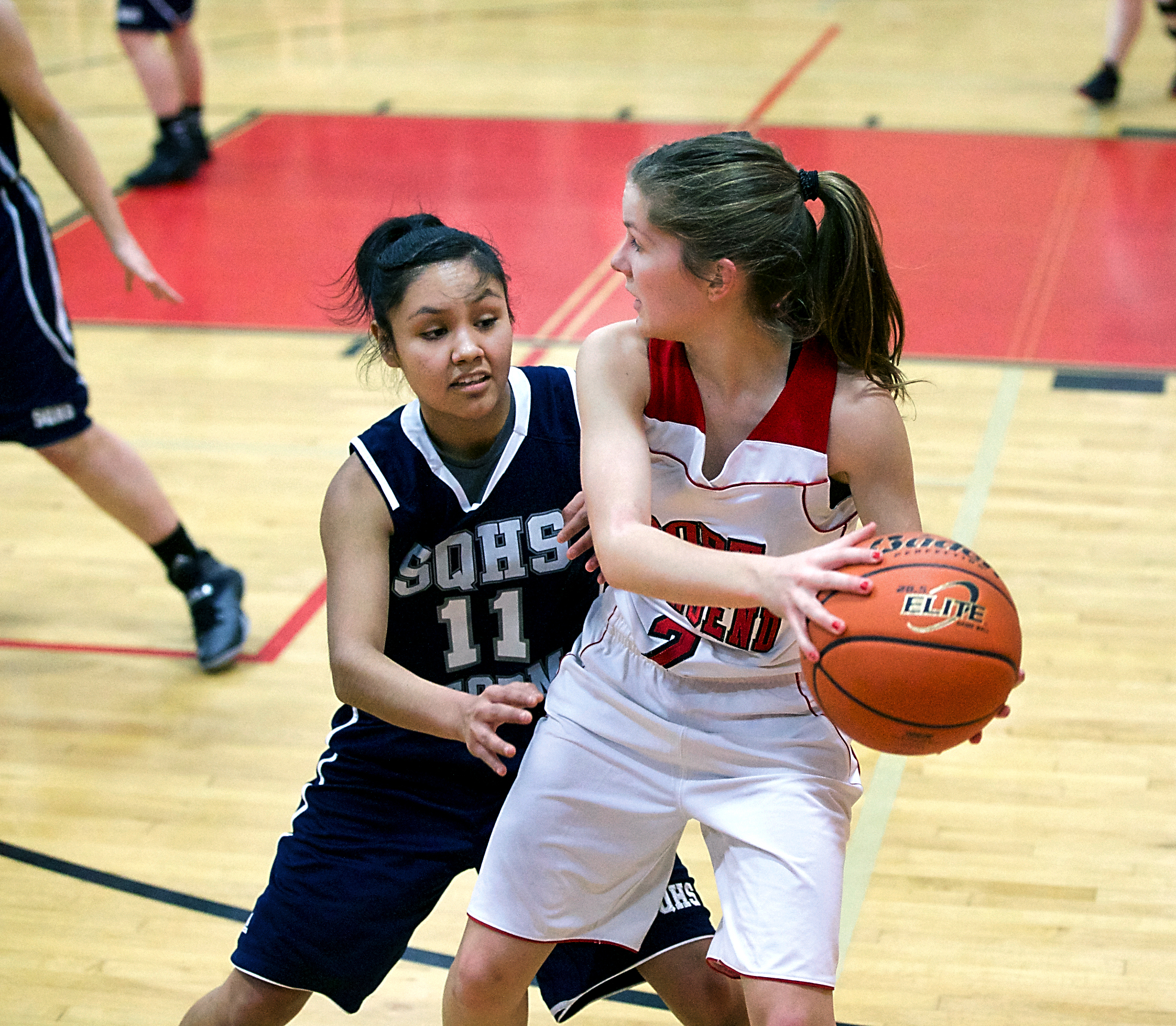 Port Townsend's Jewel Johnson keeps the ball away from Squalicum's Kamea Pino during a Crush in the Slush matchup. Steve Mullensky/for Peninsula Daily News