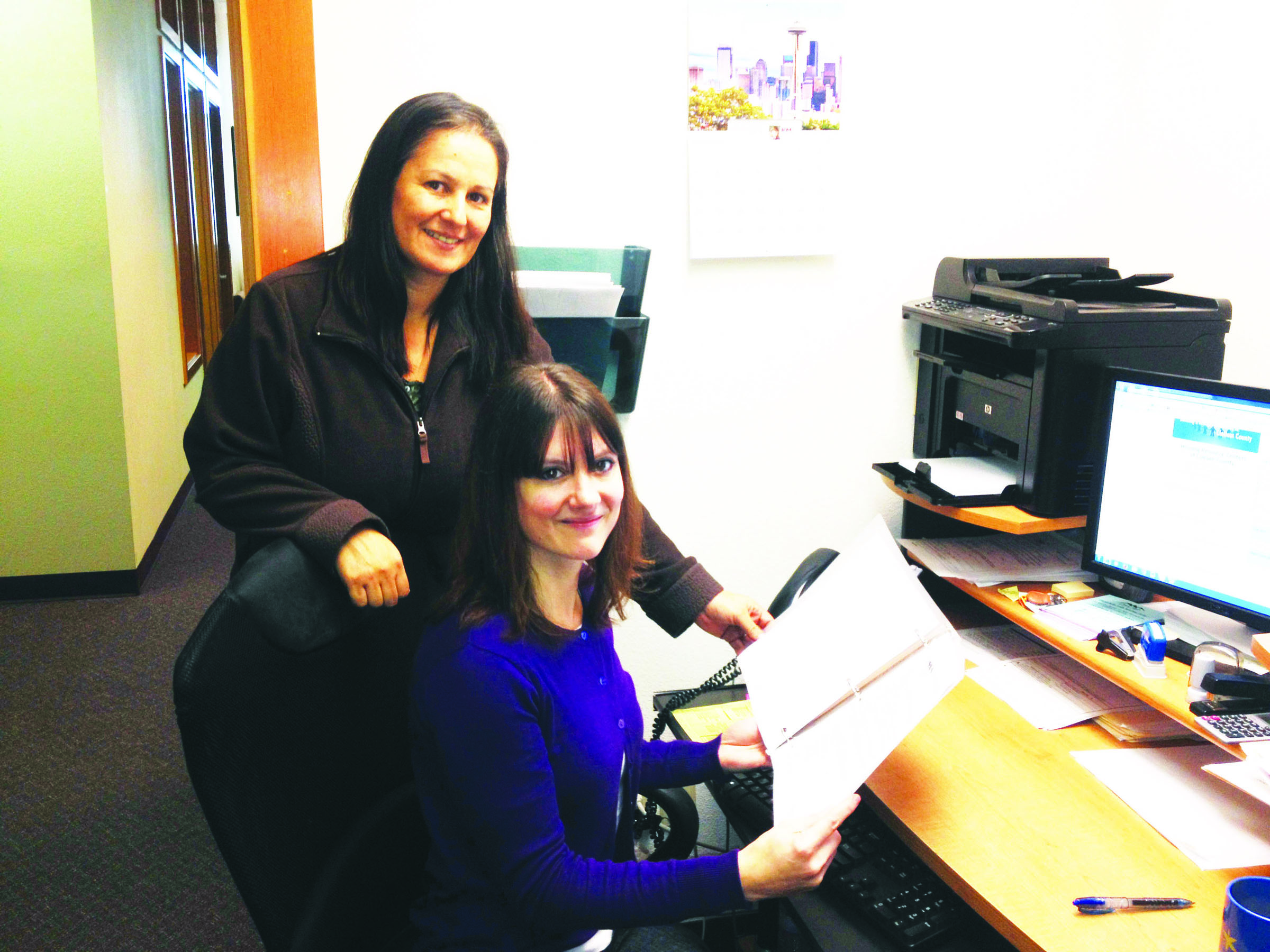 Stepping up to help by volunteering at OlyCAP is Peninsula Home Fund case manager Laura Calabria