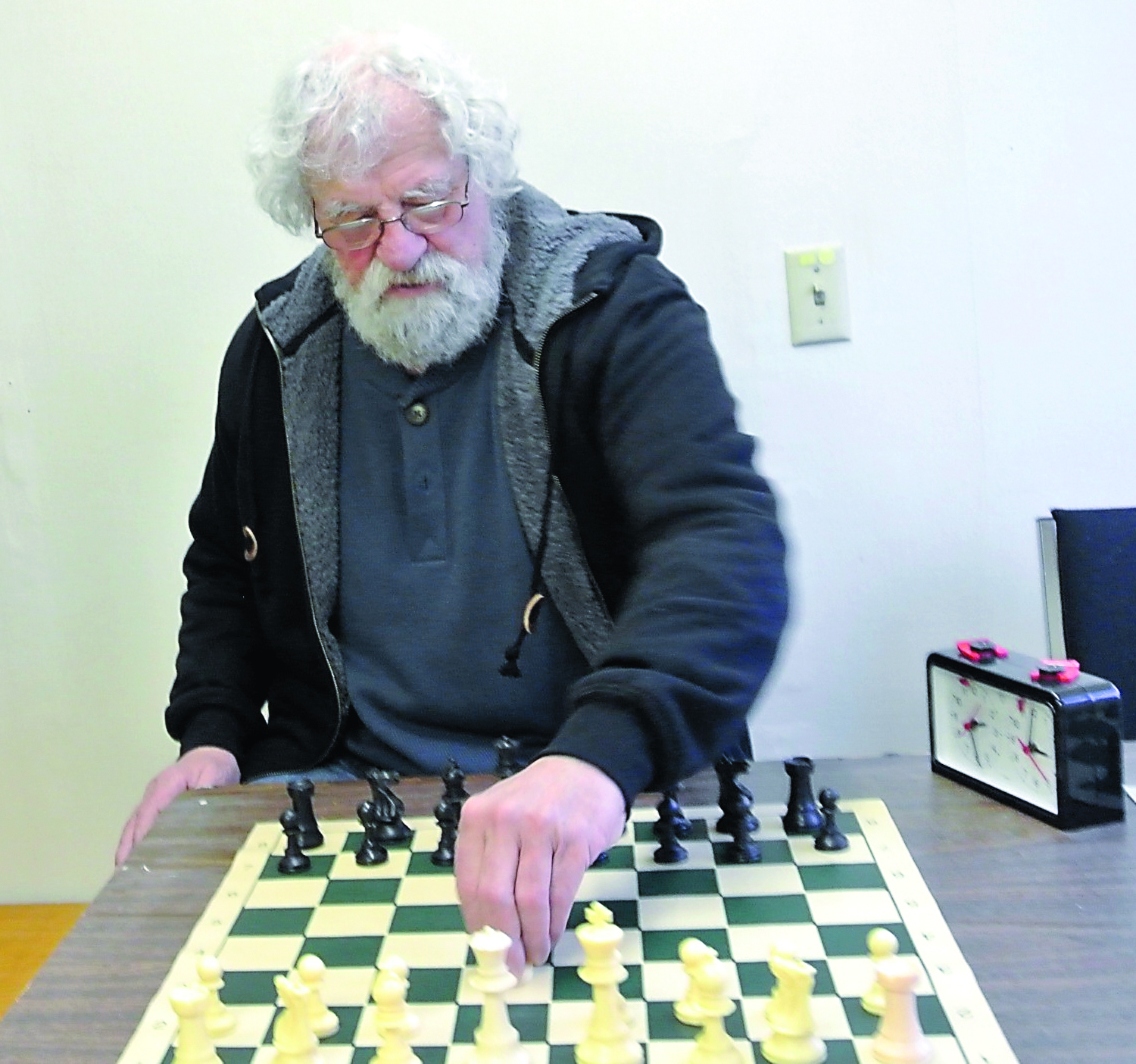 Dennis McGuire of the Last Exit on Kearney Chess Club demonstrates some moves that could be used in the annual tournament that begins this week. Prizes will be paid out to the top 10 participants. Charlie Bermant/Peninsula Daily News