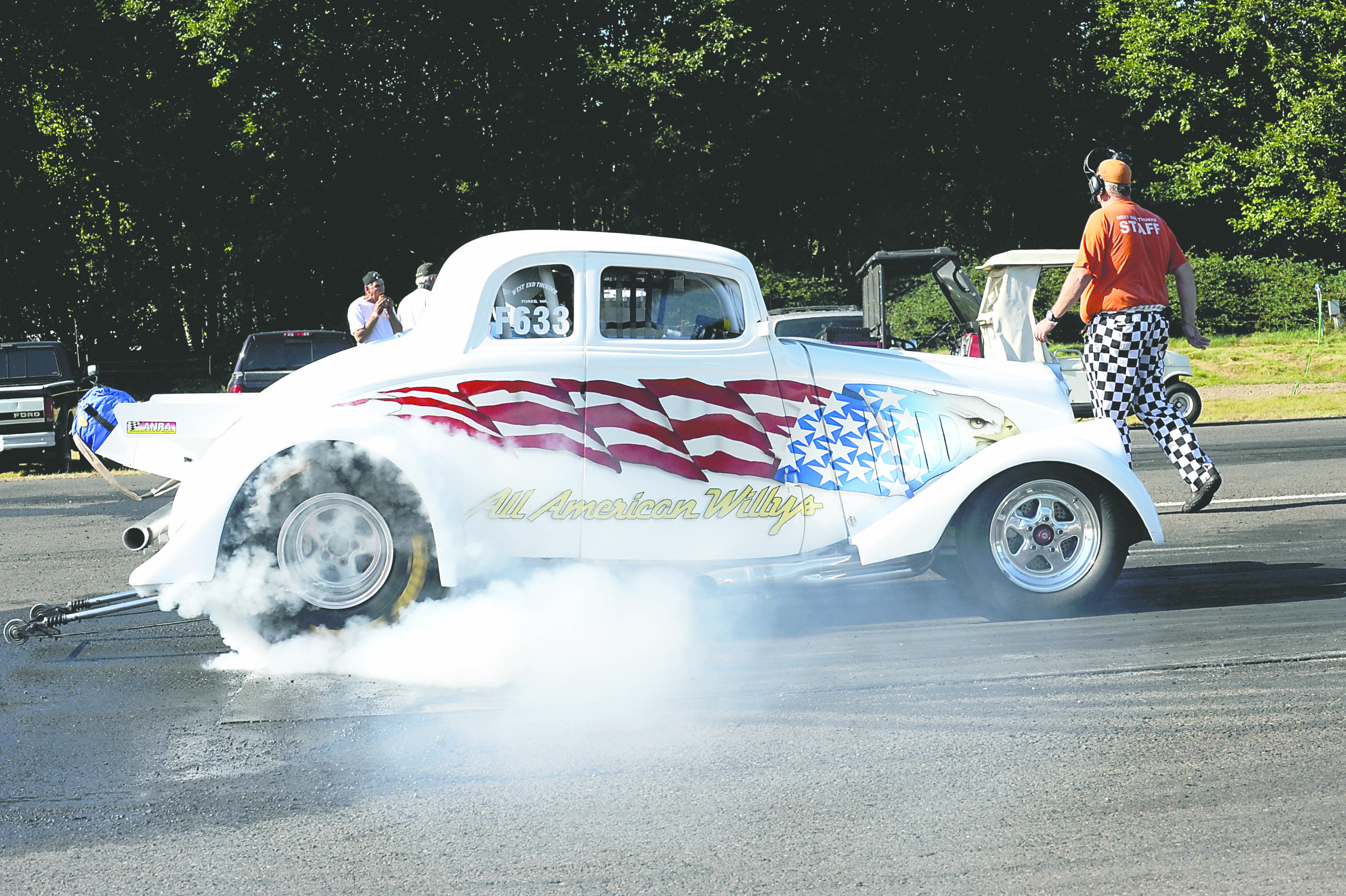 All American Willy's hotrod burns rubber as it takes off from the starting line during a West End Thunder event at Forks Municipal Airport last season.  -- Photo by Lonnie Archibald/for Peninsula Daily News