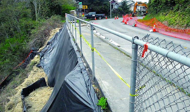 Plastic sheeting covers the spot Thursday where a retaining wall at the top of Tumwater Road in Port Angeles is being rebuilt. Keith Thorpe/Peninsula Daily News