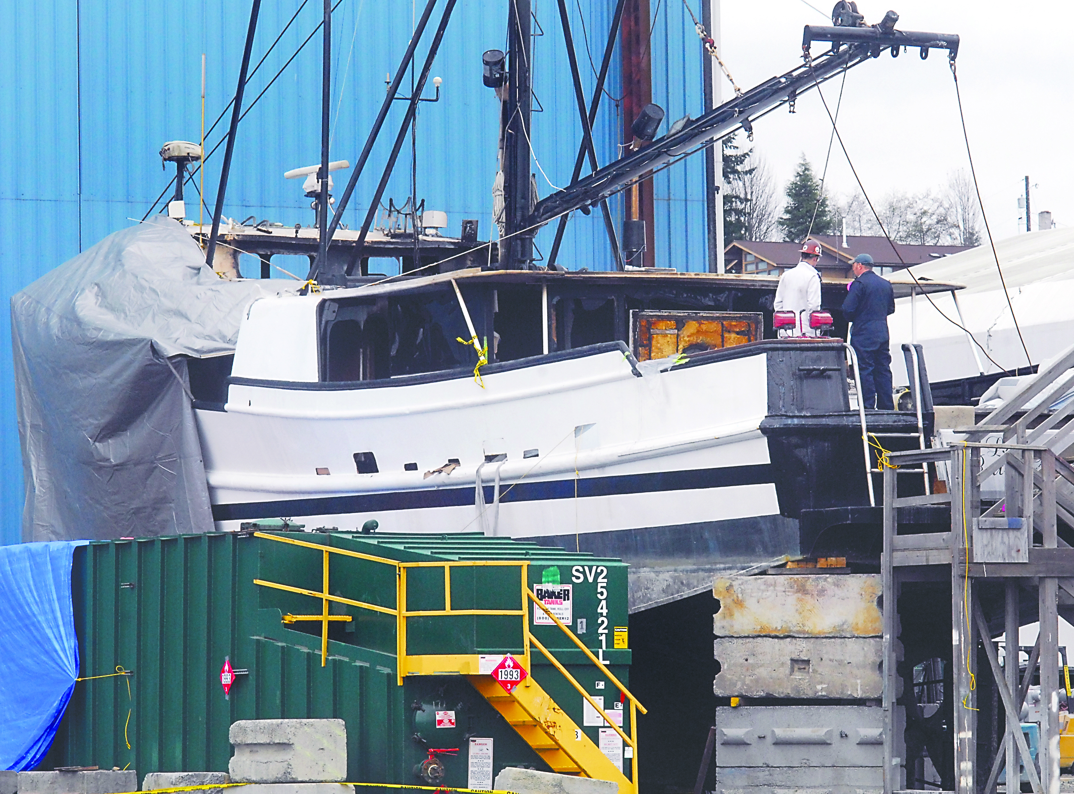 Personnel inspect the damage aboard La Rata Bastarda in the Platypus Marine yard on Tuesday.  -- Photo by Keith Thorpe/Peninsula Daily News