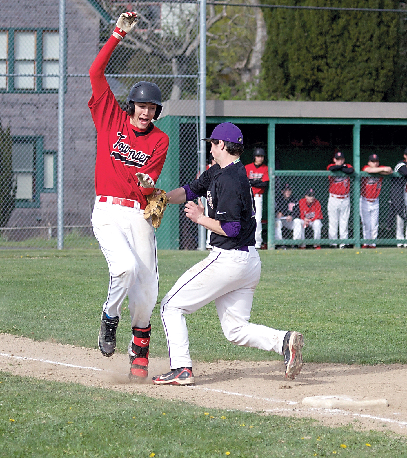Port Townsend's Cody Russell is tagged out by Sequim first baseman