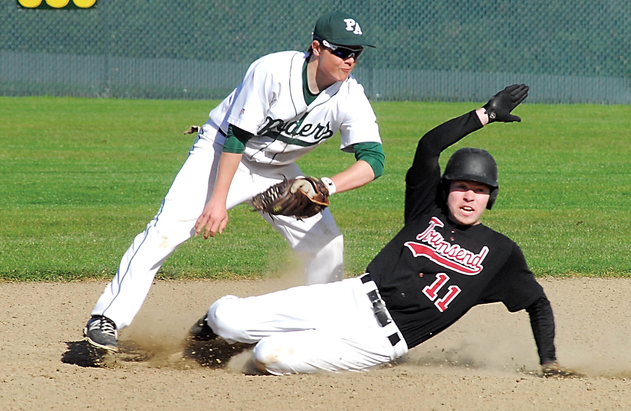 Port Townsend's Sean Dwyer looks towards the umpire after being tagged out trying to steal second base by Port Angeles's Matt Hendry. Keith Thorpe/Peninsula Daily News