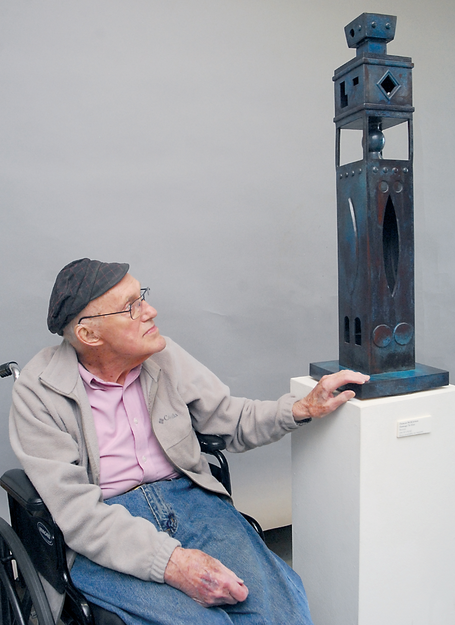 Port Angeles sculptor Duncan McKiernan looks at his sculpture Homage to Elza