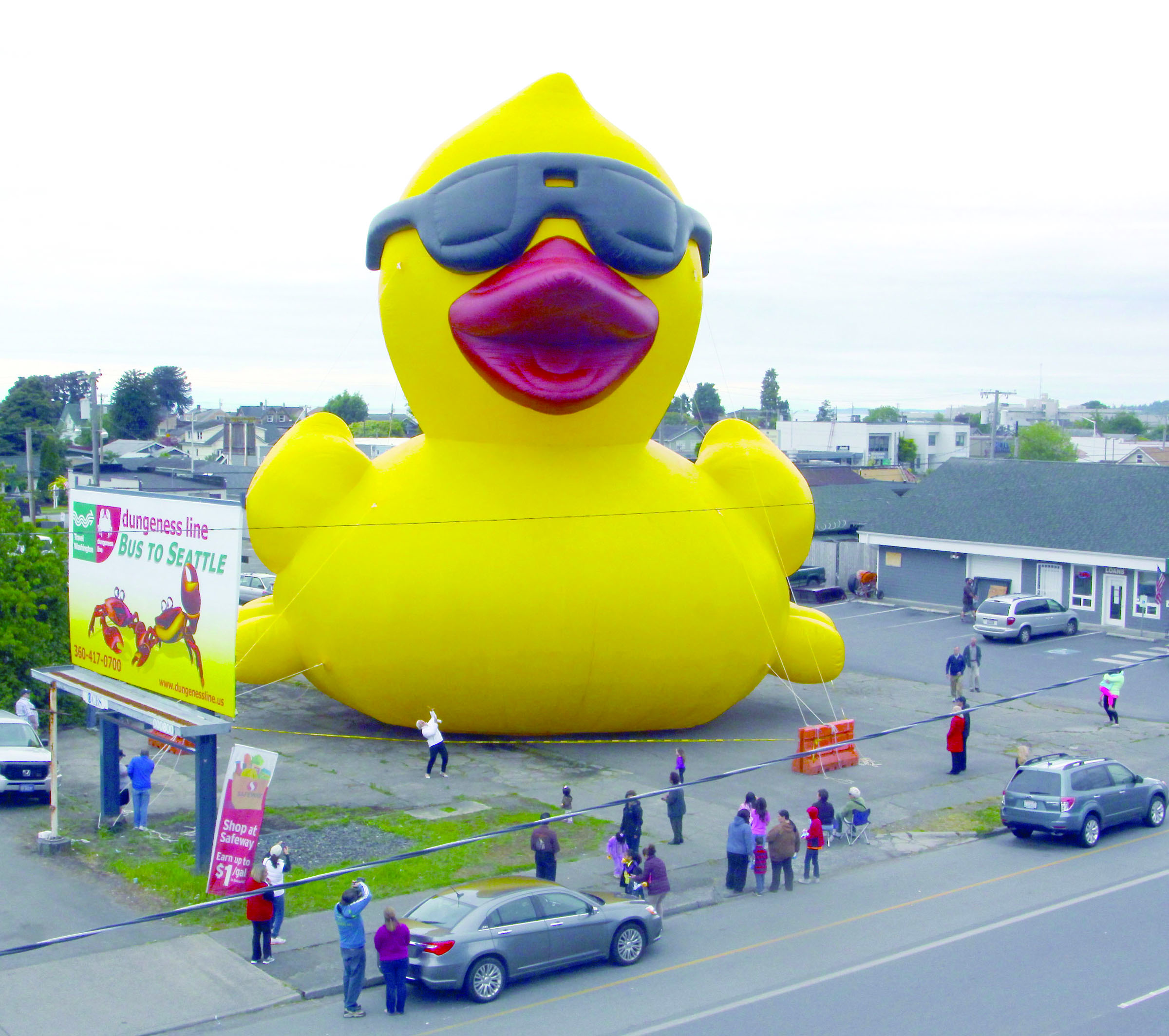A 65-foot-tall rubber duck dwarfs a billboard at left on East First Street in Port Angeles. — Dave Logan/for Peninsula Daily News
