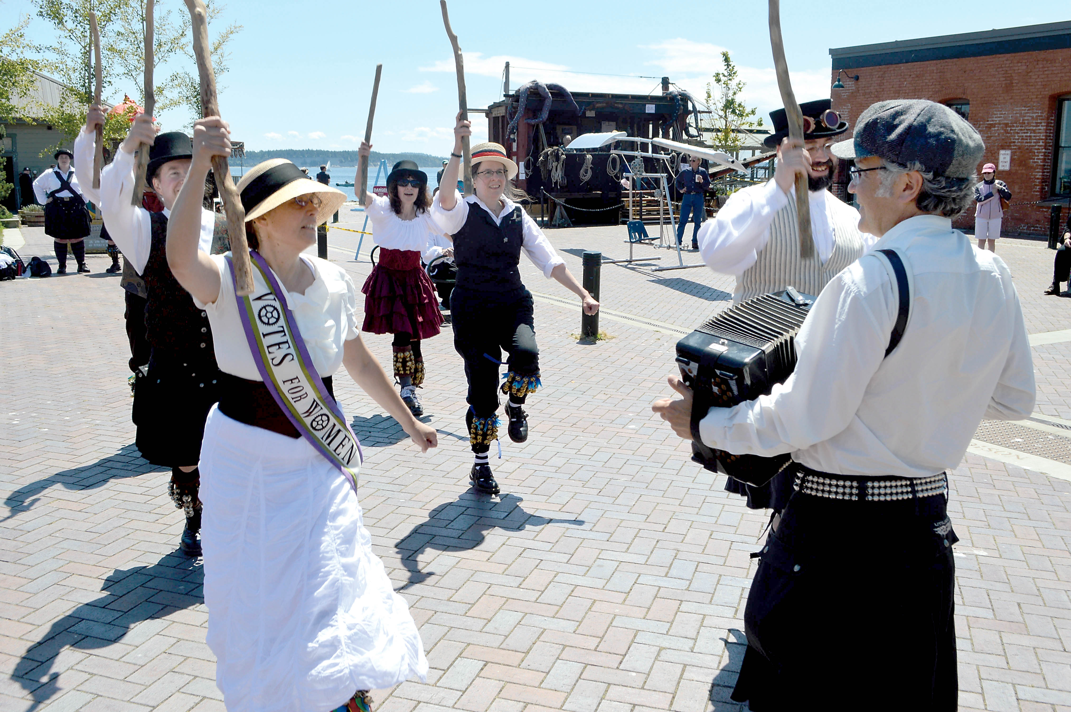 The Seattle-based Sound and Fury Morris & Sword traditional British dance troupe does a jig at Pope Marine Park in Port Townsend as part of the Brass Screw Confederacy’s third Steampunk Festival on Saturday.  —Photo by Joe Smillie/Peninsula Daily News