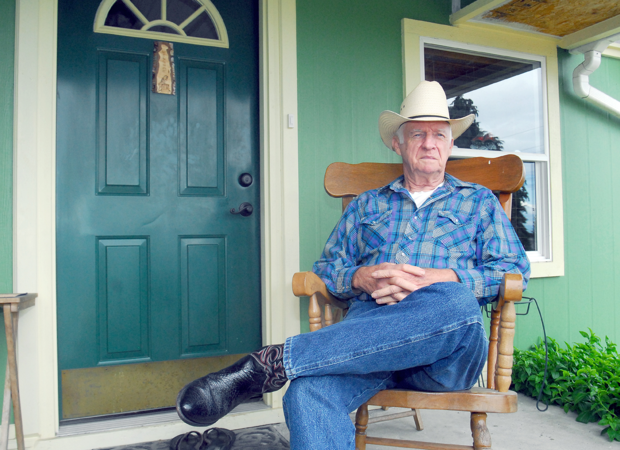 Charles W. Binney sits on the front porch of his Port Angeles home where he said he was assaulted by a man who tried to enter his house in April. Keith Thorpe/Peninsula Daily News