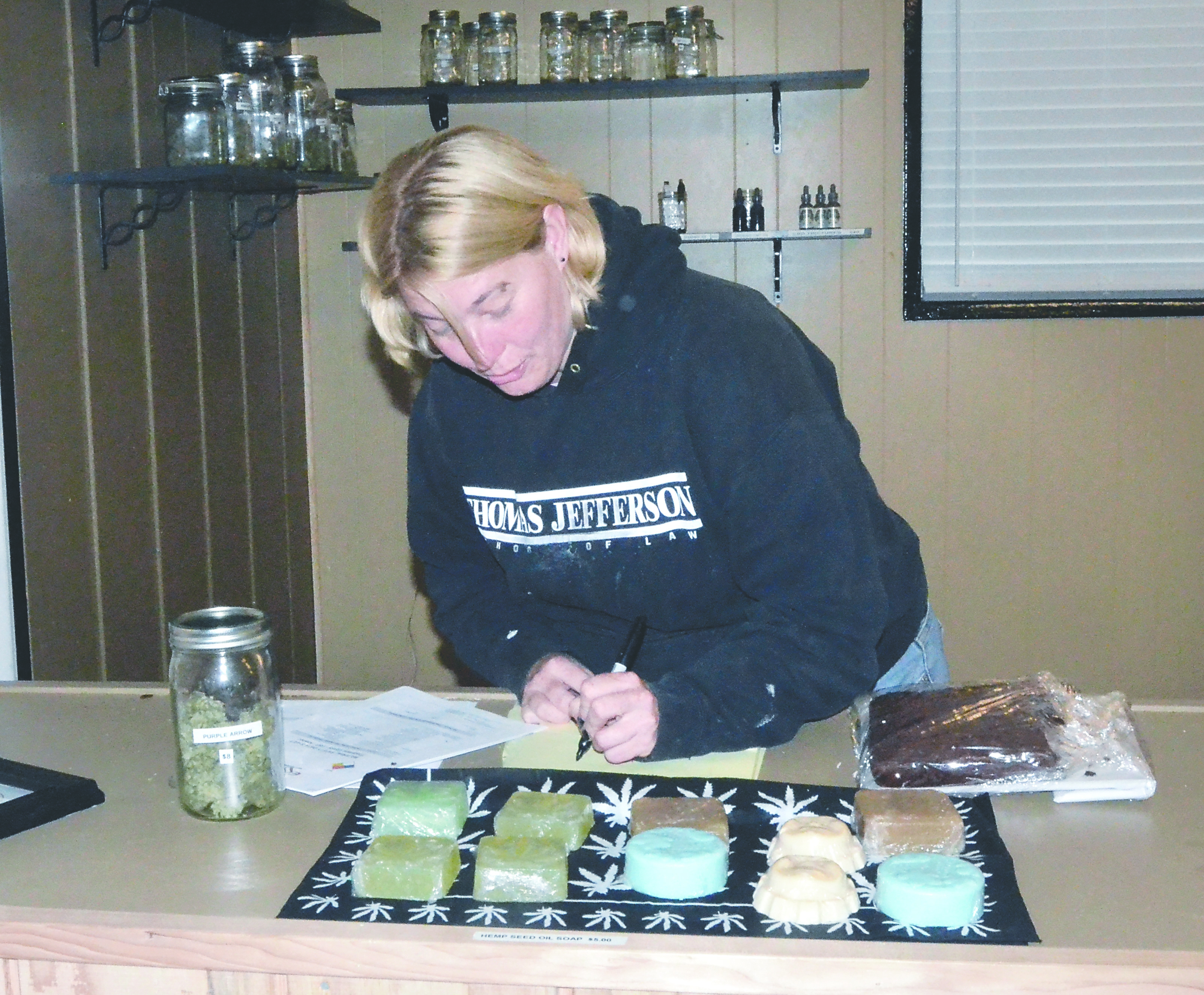 Nicole Black of the Brinnon Herbal Collective in Brinnon inventories some products that will be displayed at Saturday’s medical marijuana farmers market