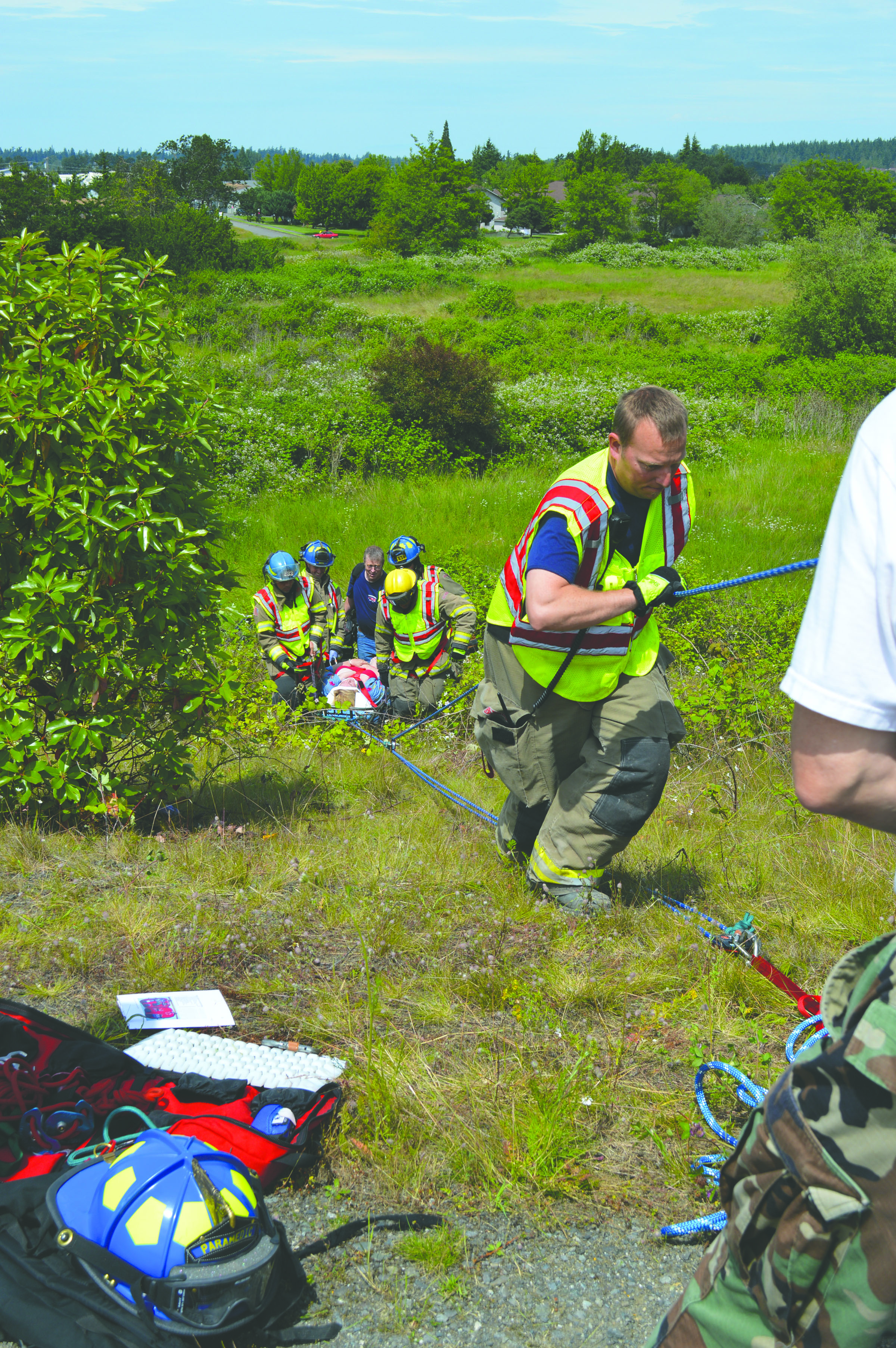 Rescue workers pull an injured woman who drove her Toyota Land Cruiser down a 60-foot