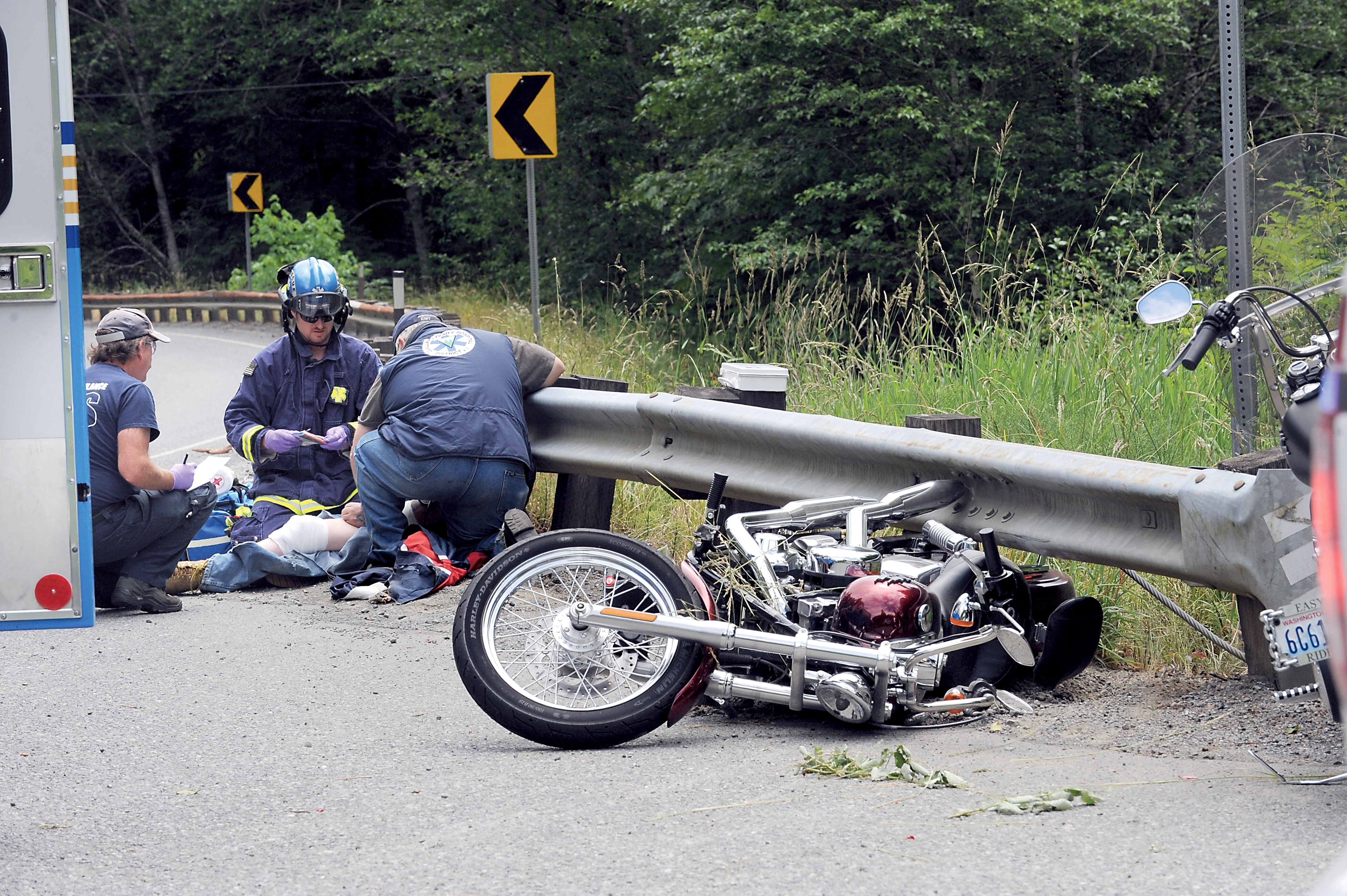 Emergency responders treat a man who was injured Wednesday when he was thrown from his motorcycle on state Highway 113 near its intersection with U.S. Highway 101 in Beaver. Lonnie Archibald/for Peninsula Daily News