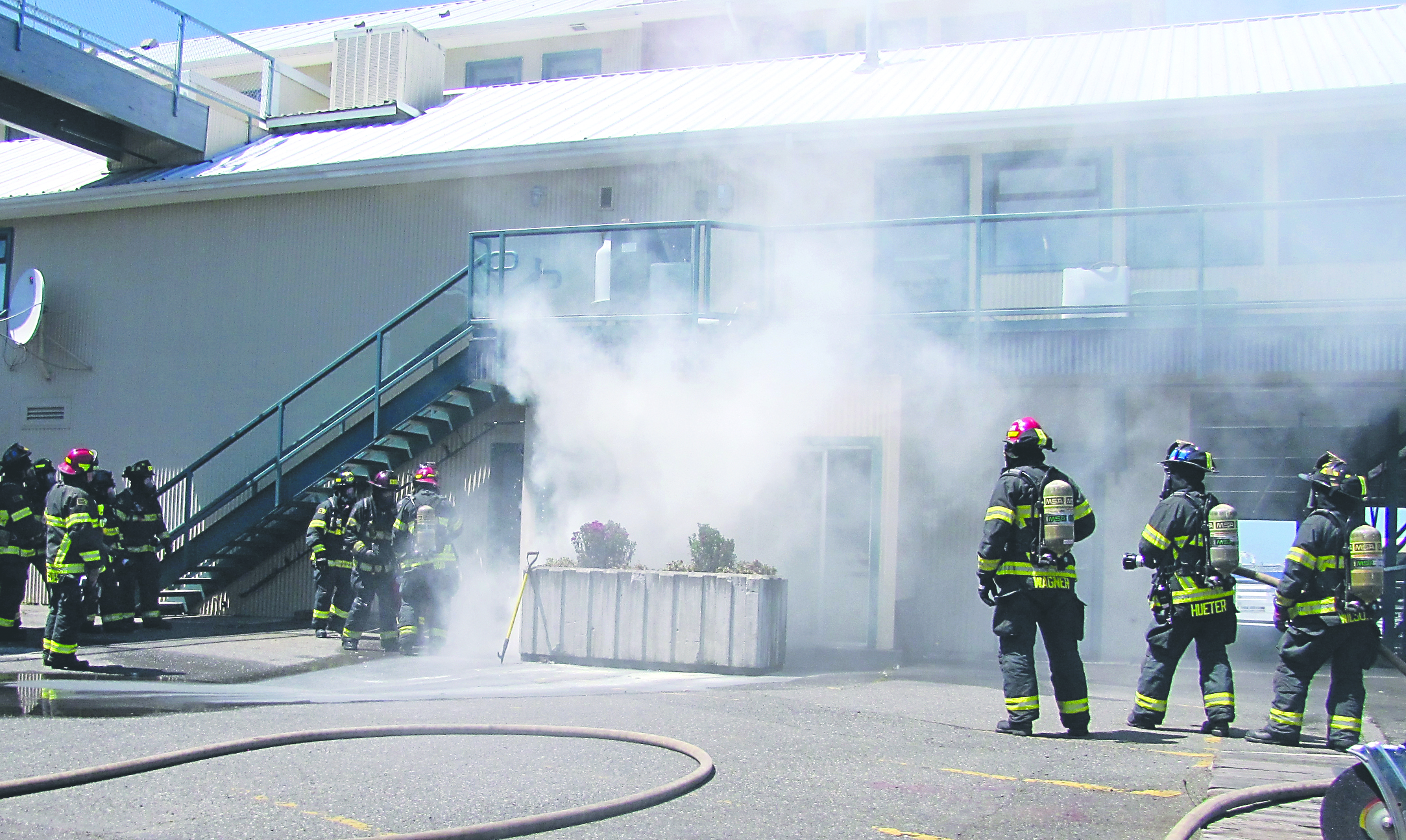 Smoke billows from a storage battery room at The Landing mall on the Port Angeles waterfront as firefighters determine the best way to extinguish the smoky fire that forced evacuation of the large commercial building. Keith Thorpe/Peninsula Daily News