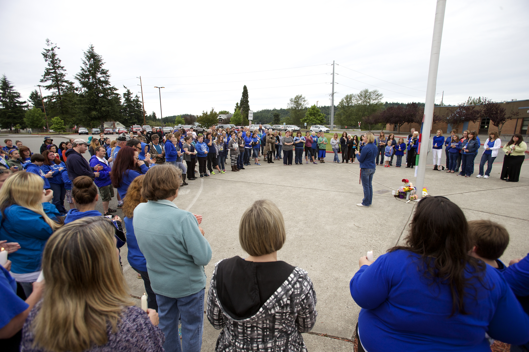 About 130 people gather around the flagpole at Chimacum High School on Saturday for a candlelight vigil in memory of Lindsey Mustread