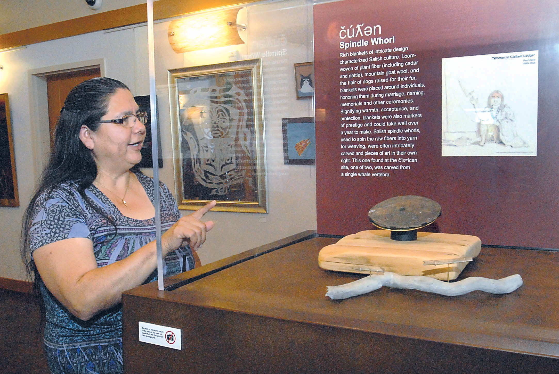 Lower Elwha Klallam Tribal Chairwoman Frances Charles looks over a display containing a spindle whorl for spinning fibers after the unveiling of tribal artifacts now on display at the Elwha Klallam Heritage Center in Port Angeles. Keith Thorpe/Peninsula Daily News