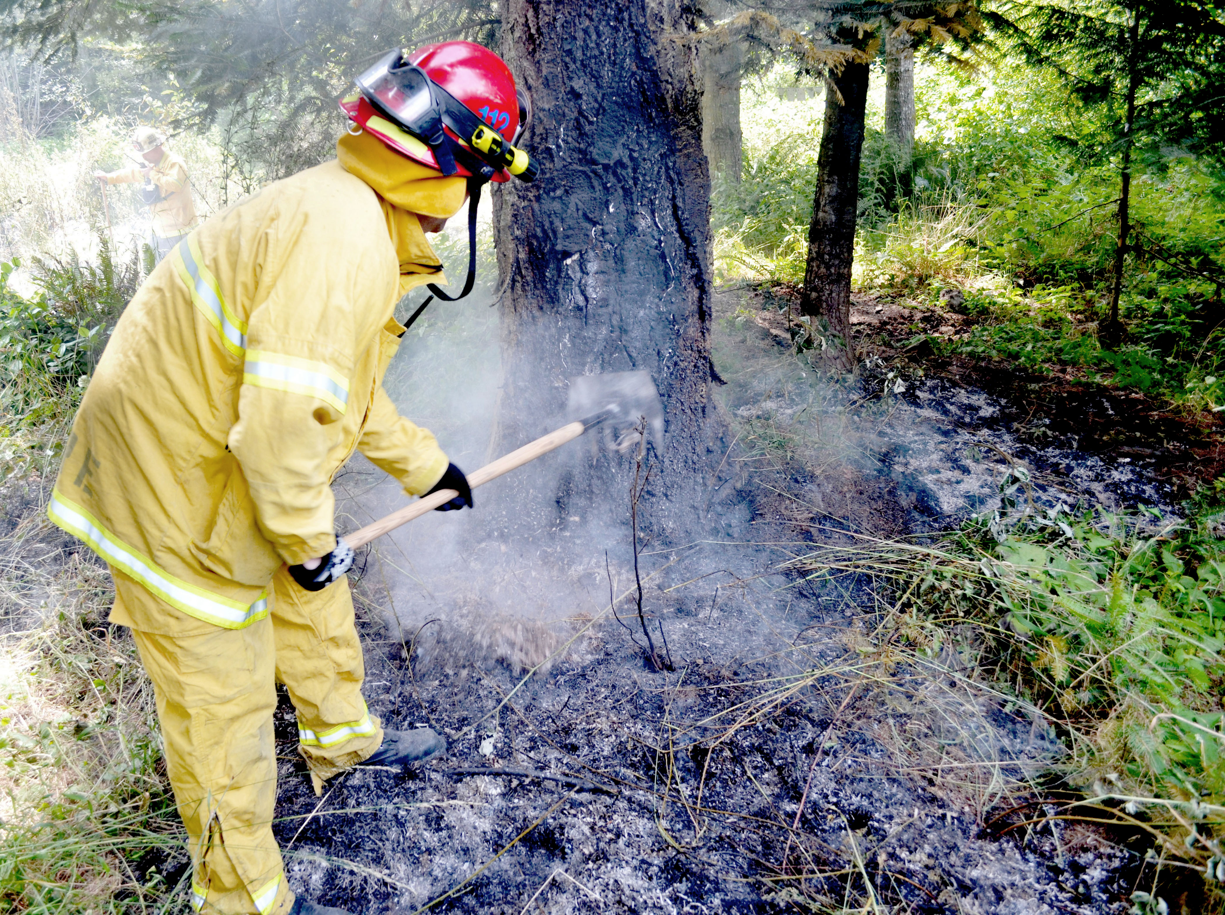 A Jefferson County Fire-Rescue firefighter works one of the two Sunday brush fires.  Photo by Bill Beezley/East Jefferson Fire-Rescue