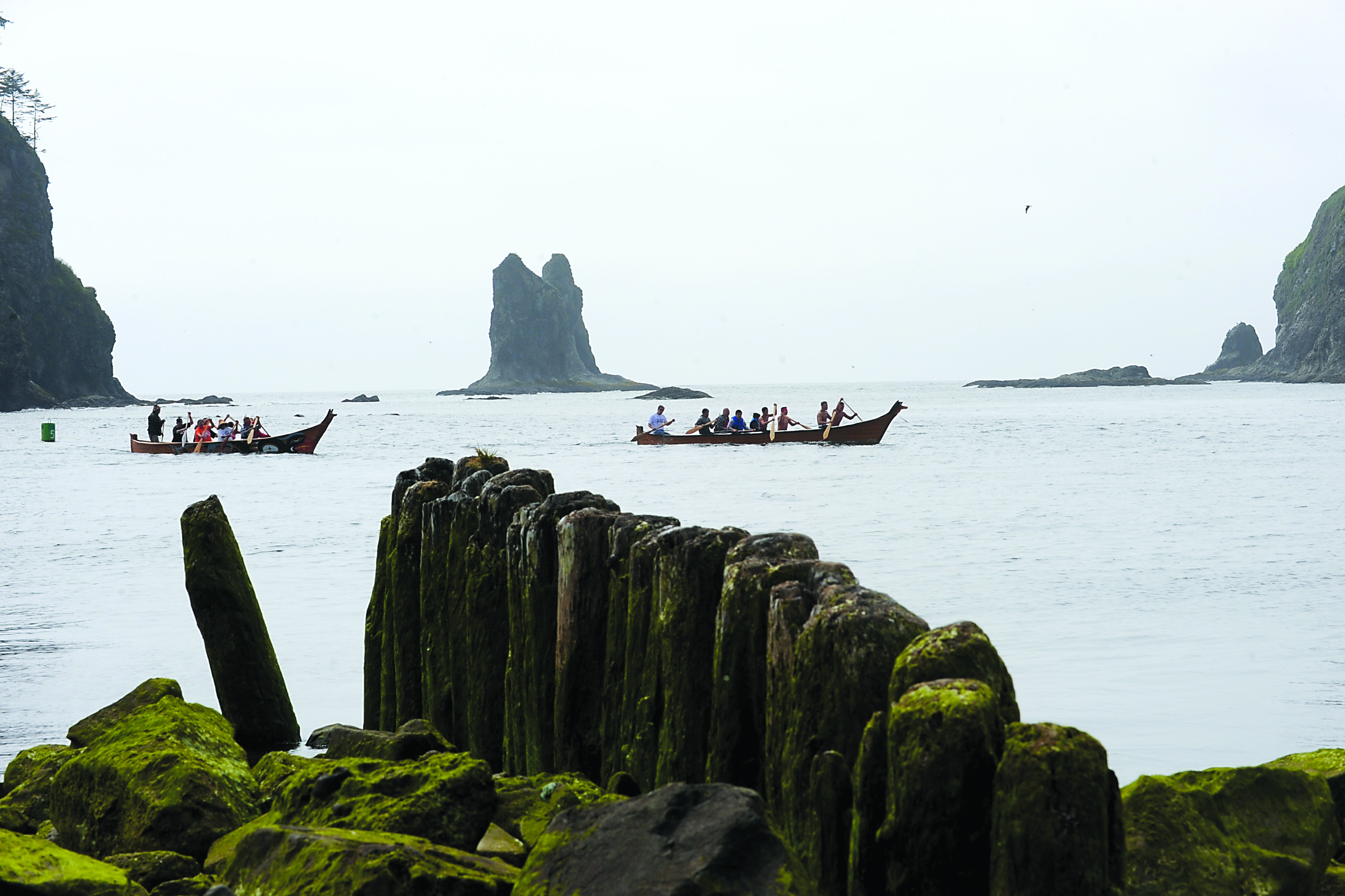 Two Quileute tribal welcoming canoes head up the Quillayute River on Thursday as they await paddlers coming into LaPush. Lonnie Archibald/for Peninsula Daily News
