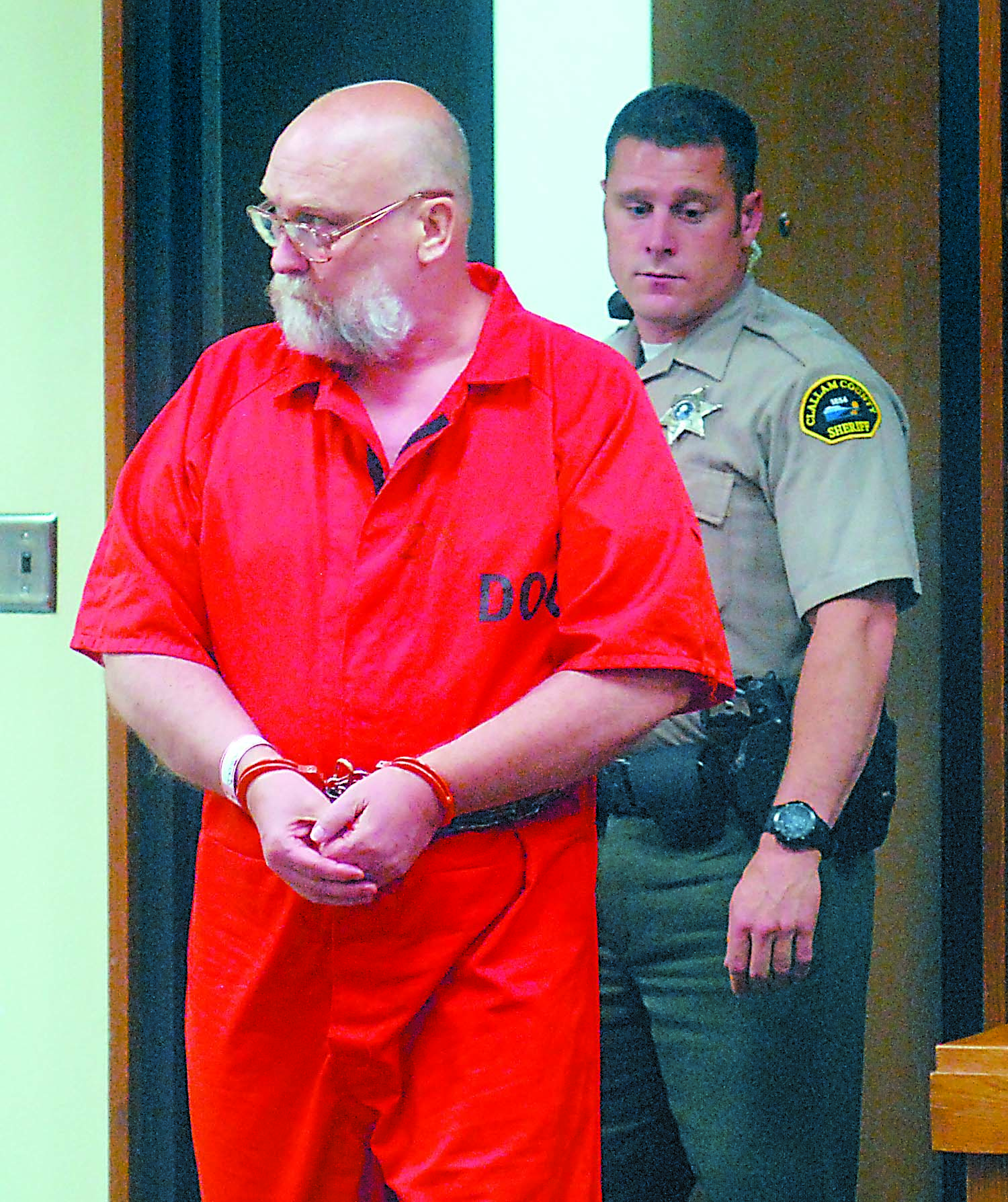 Darold Stenson enters Clallam County Superior Court for a status hearing on Friday accompanied by court sercurity officer Eric Morris.  -- Photo by Keith Thorpe/Peninsula Daily News
