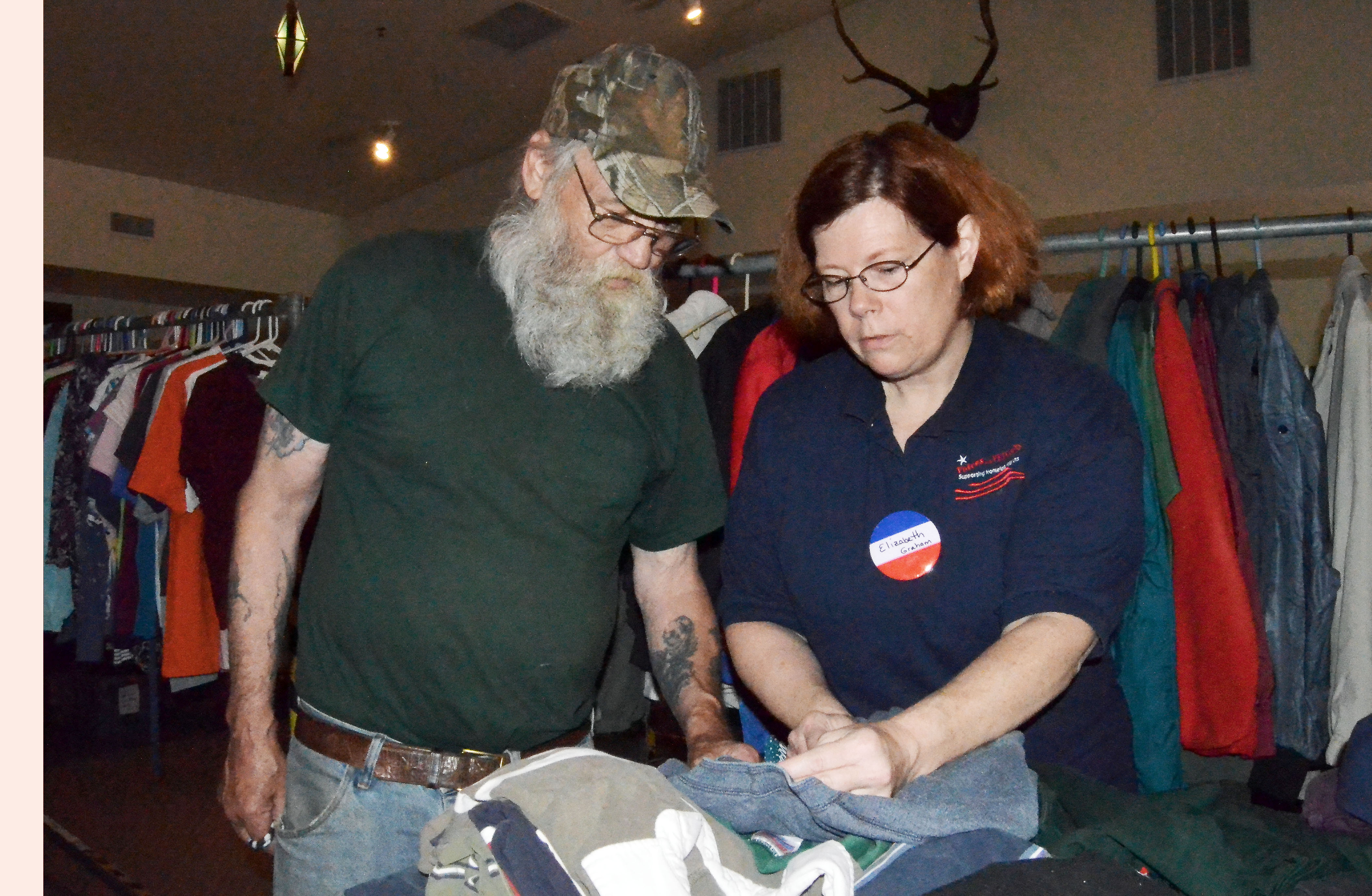 Veteran Howard Shipley selects clothes with the help of Elizabeth Graham at the “Stand Down” event in Port Townsend on Monday. —Photo by Charlie Bermant/Peninsula Daily News