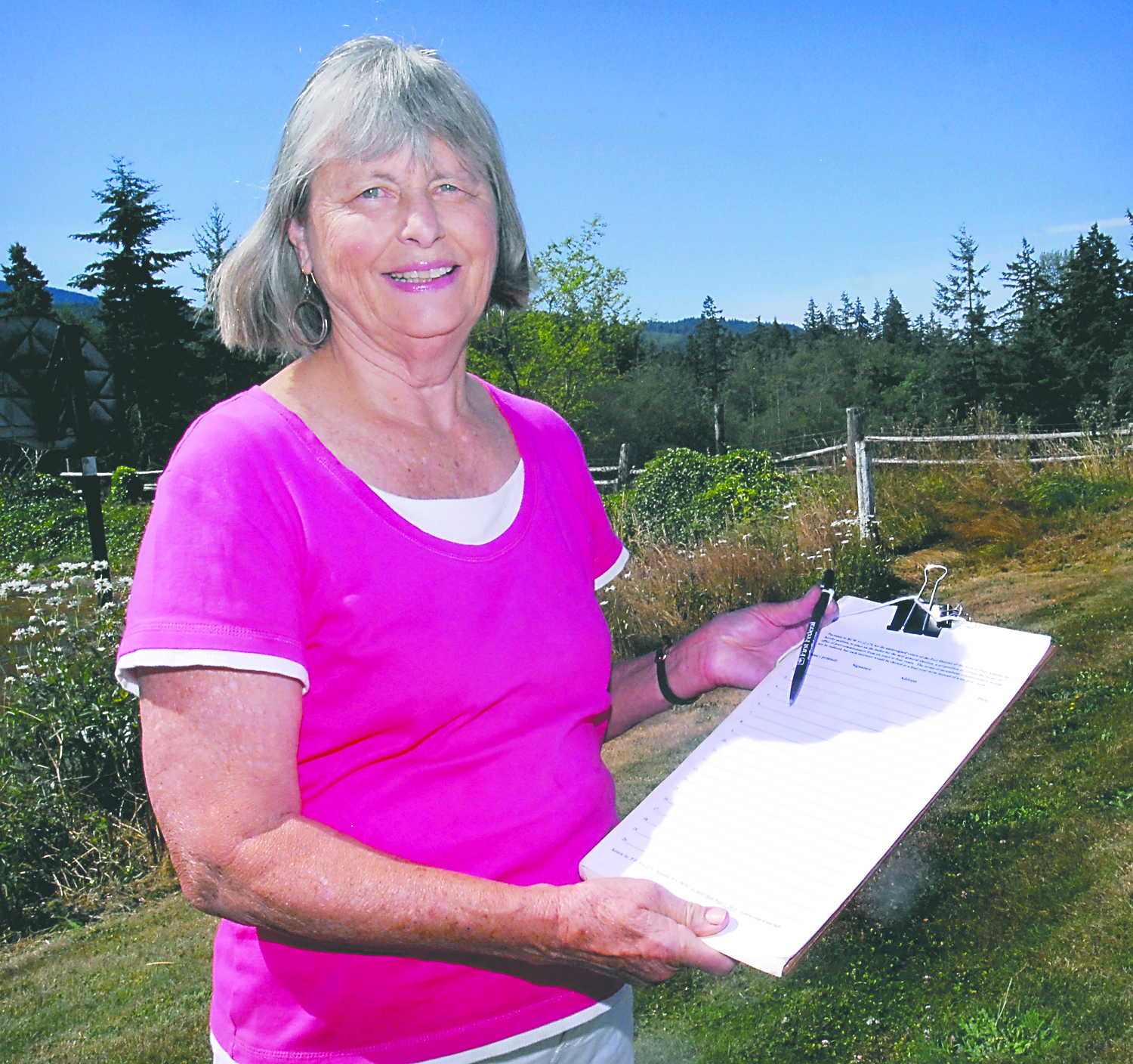 Norma Turner of Port Angeles holds a petition on Friday with the hopes that she will gather enough signatures of Clallam County voters to place a measure on the ballot that would change the composition of the board of commissioners for the Port of Port Angeles.  -- Photo by Keith Thorpe/Peninsula Daily News