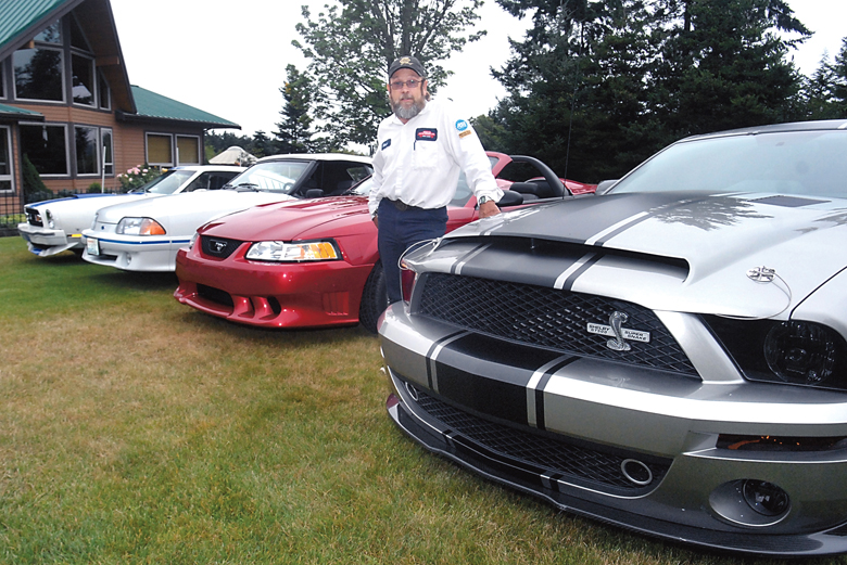 Marv Fowler of Sequim stands next to a line of his Ford Mustangs that he will show at this weekend's Kiwanis Car Show in Port Townsend. Keith Thorpe/Peninsula Daily News