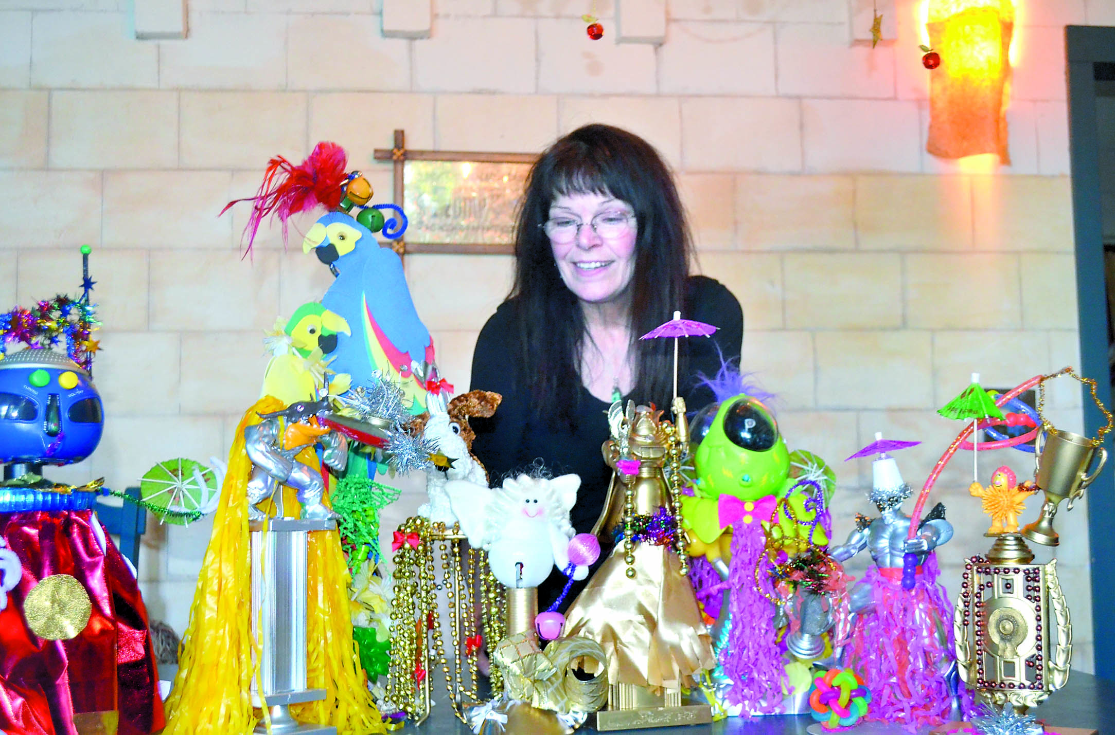 Jeanne Moore shows off some of the unconventional trophies she created for the winners of the Uptown Street Fair parade