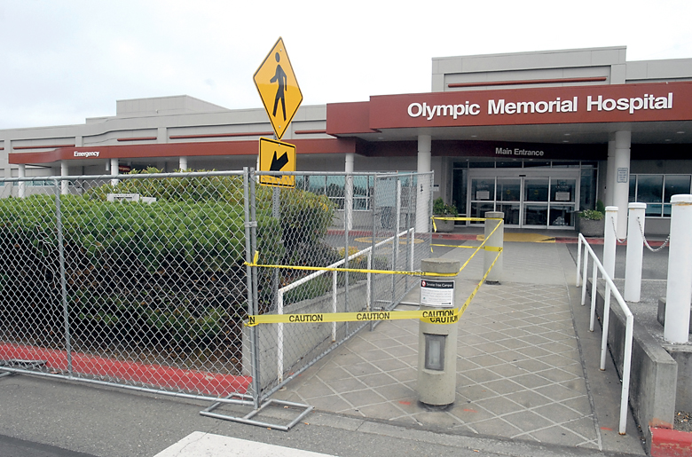 Temporary fencing and caution tape mark the construction zone Thursday for an expansion of the emergency room at Olympic Medical Center in Port Angeles. Keith Thorpe/Peninsula Daily News