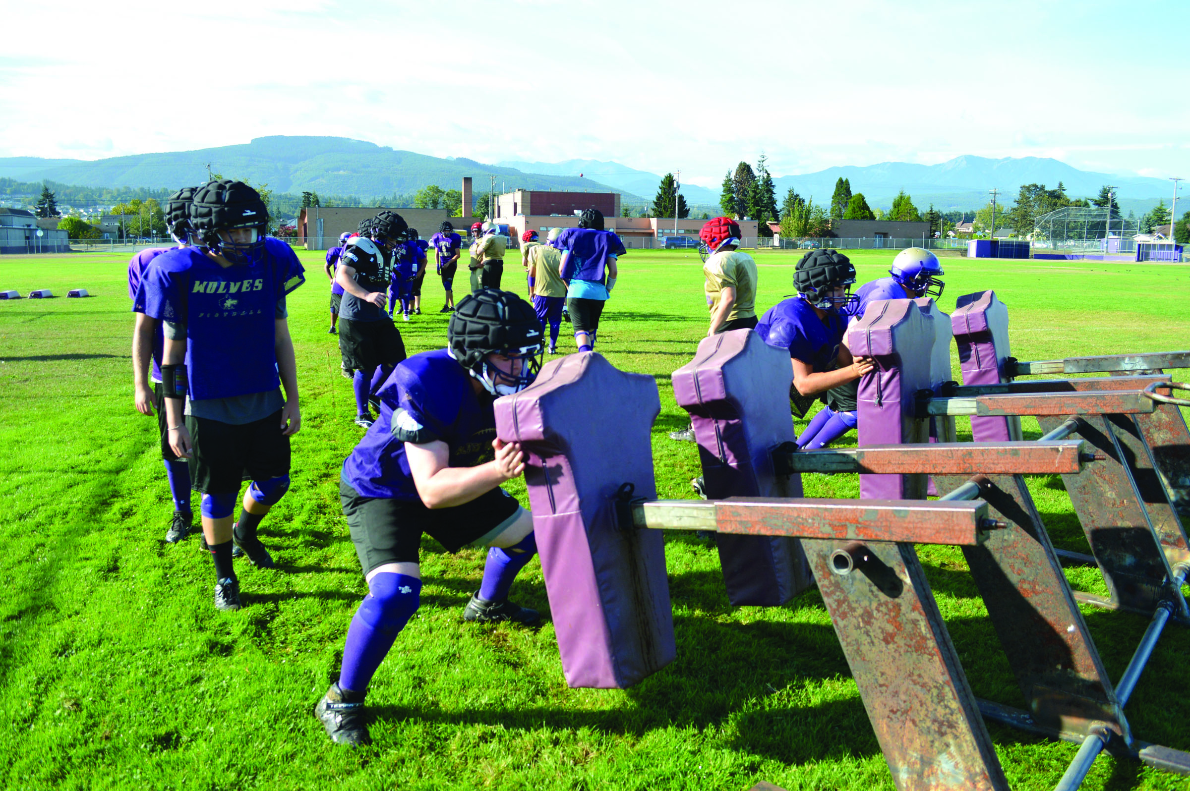 Sequim players work with a football sled during a practice late last week. The Wolves open their season Friday night at home against New Westminster