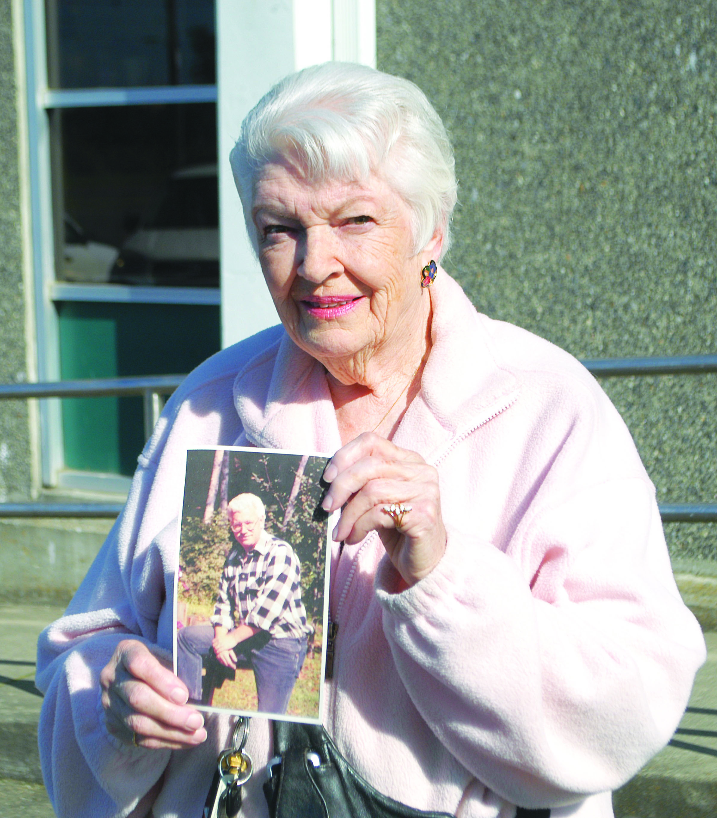 Jinny Longfellow of Port Angeles holds a photo of her younger brother