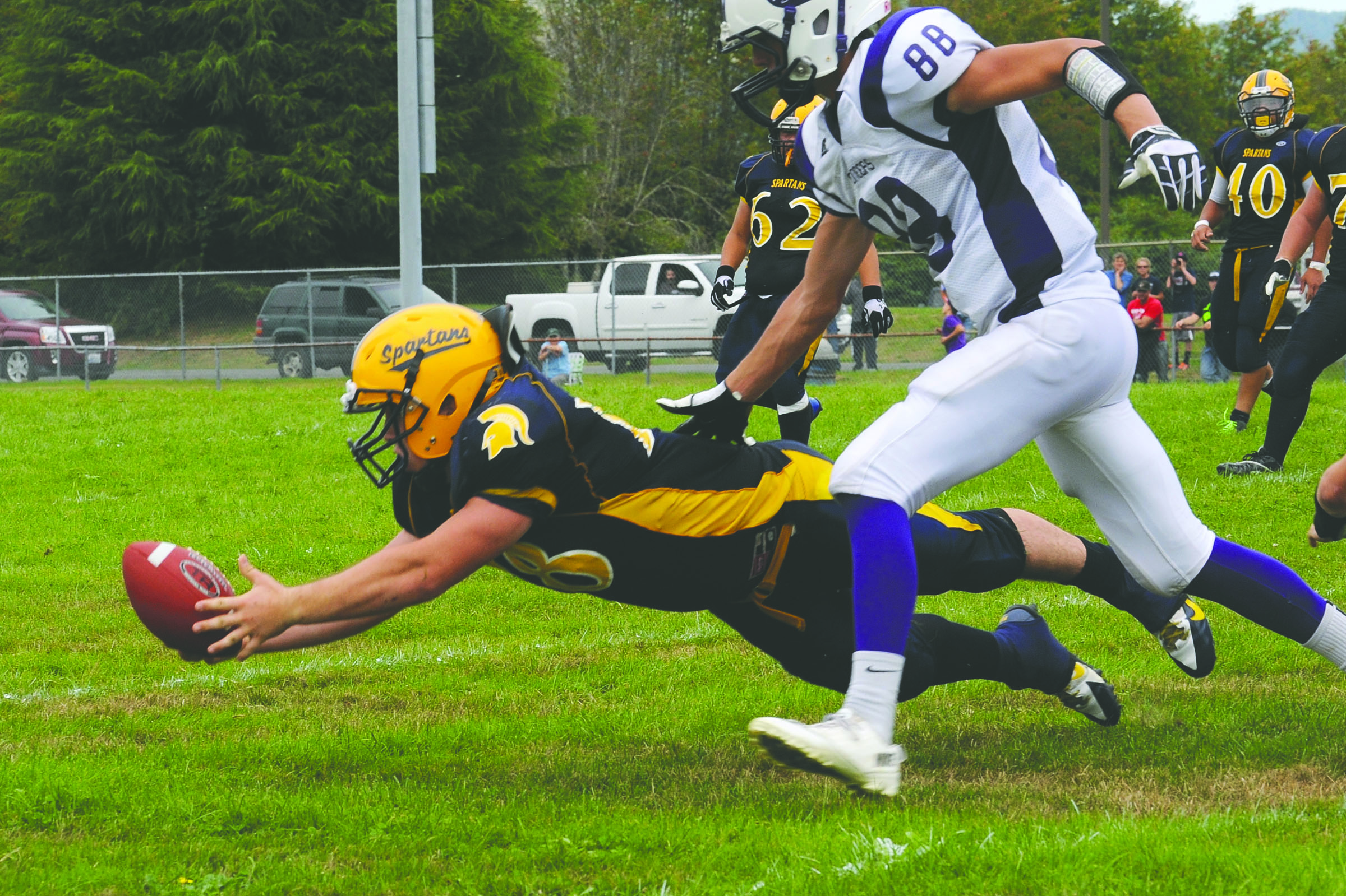 Forks running back Brett Pederson dives for a pass during the Spartans' nonconference game against Nooksack Valley. Lonnie Archibald/for Peninsula Daily News