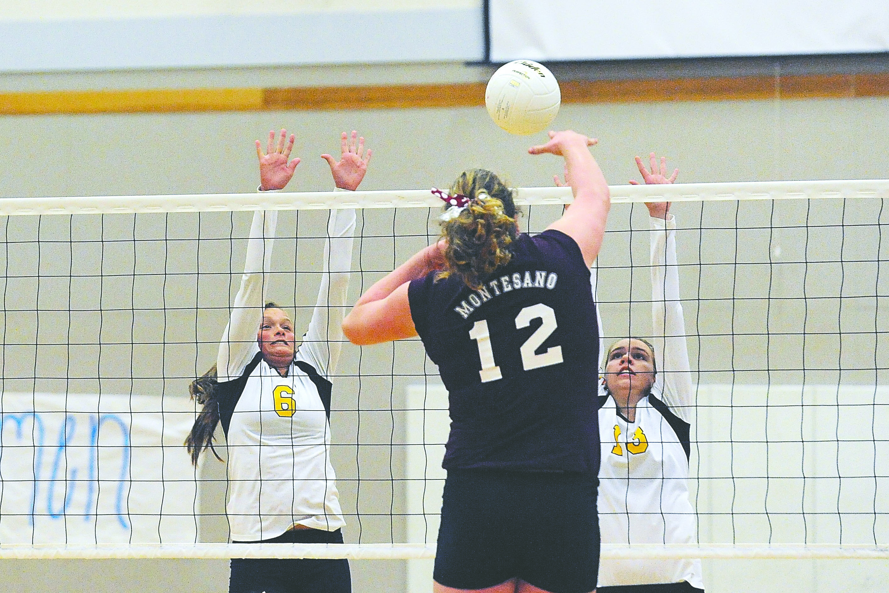 Forks' Sarah Adams (6) and Erin Weekes (13) attempt to block a short by Montesano's Jordan Spradlin. Lonnie Archibald/for Peninsula Daily News