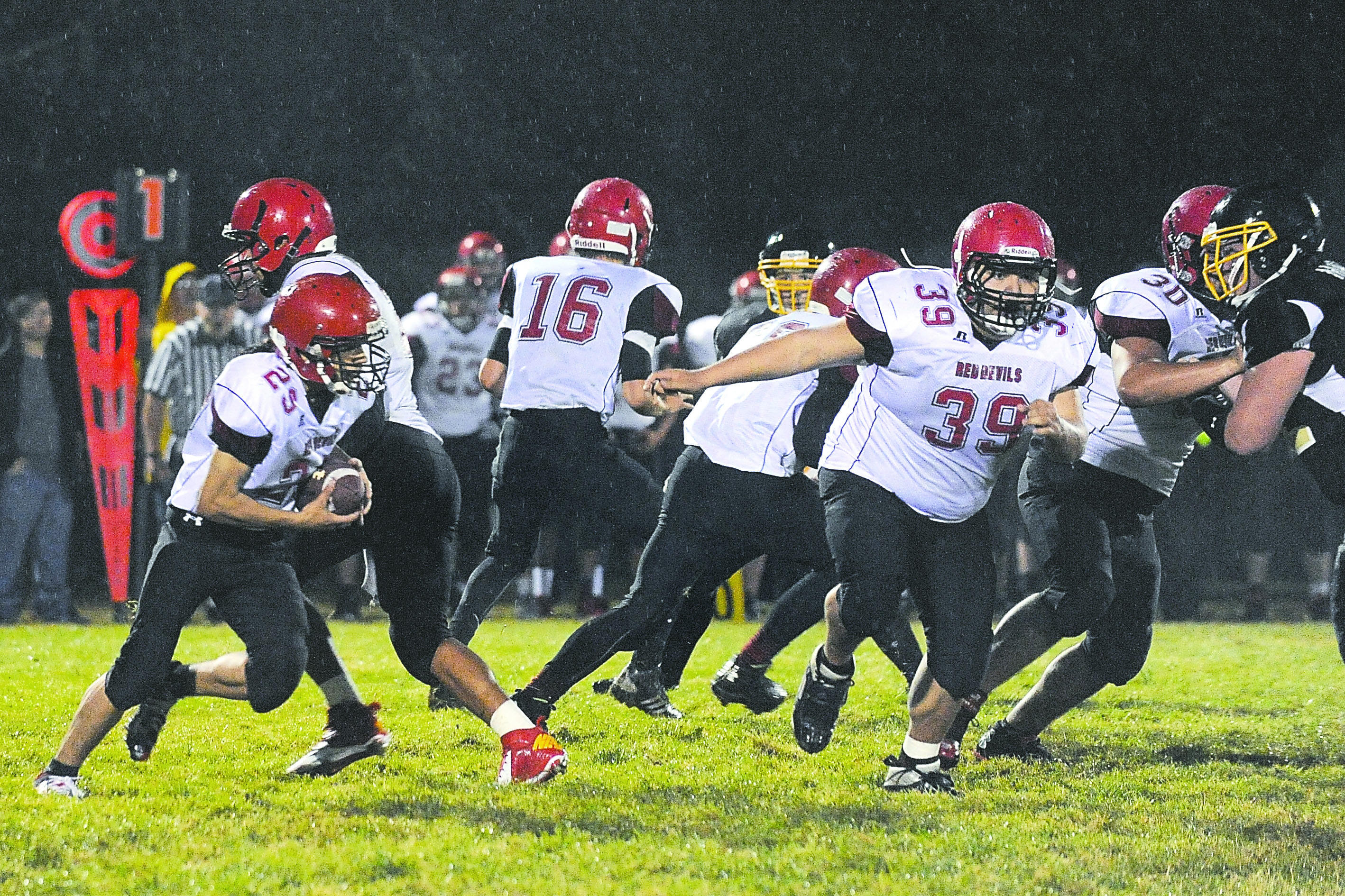 Neah Bay quarterback Josiah Green hands off to Collin Haupt at the start of what turned out to be a 70-yard run against Clallam Bay last month. Also in on the play are Carl Mack (39) and Bill Hanson (30). Lonnie Archibald/for Peninsula Daily News