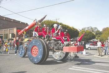 Acme Racing of Gig Harbor rolls down Water Street at the end of the 2013 Kinetic Sculpture Parade in downtown Port Townsend. Peninsula Daily News