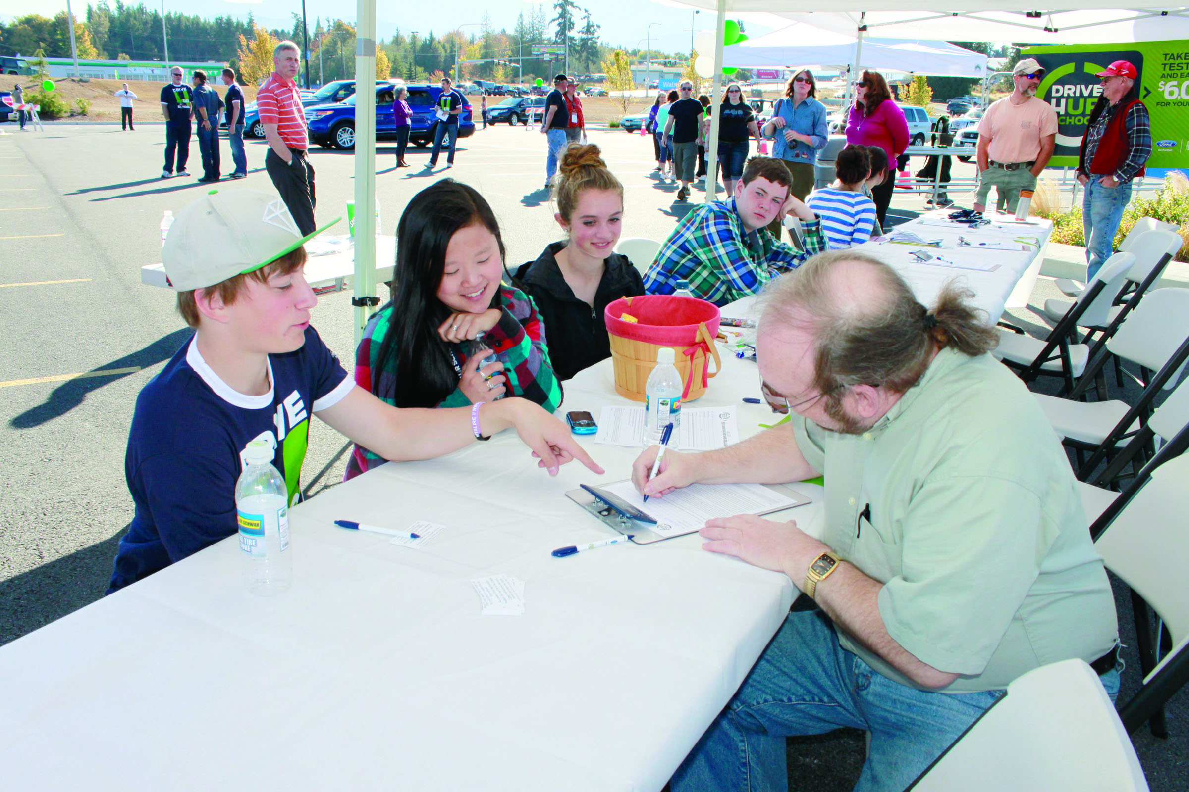 Student volunteers from the Port Angeles High School orchestra help out during the Drive One 4 UR School event. They are
