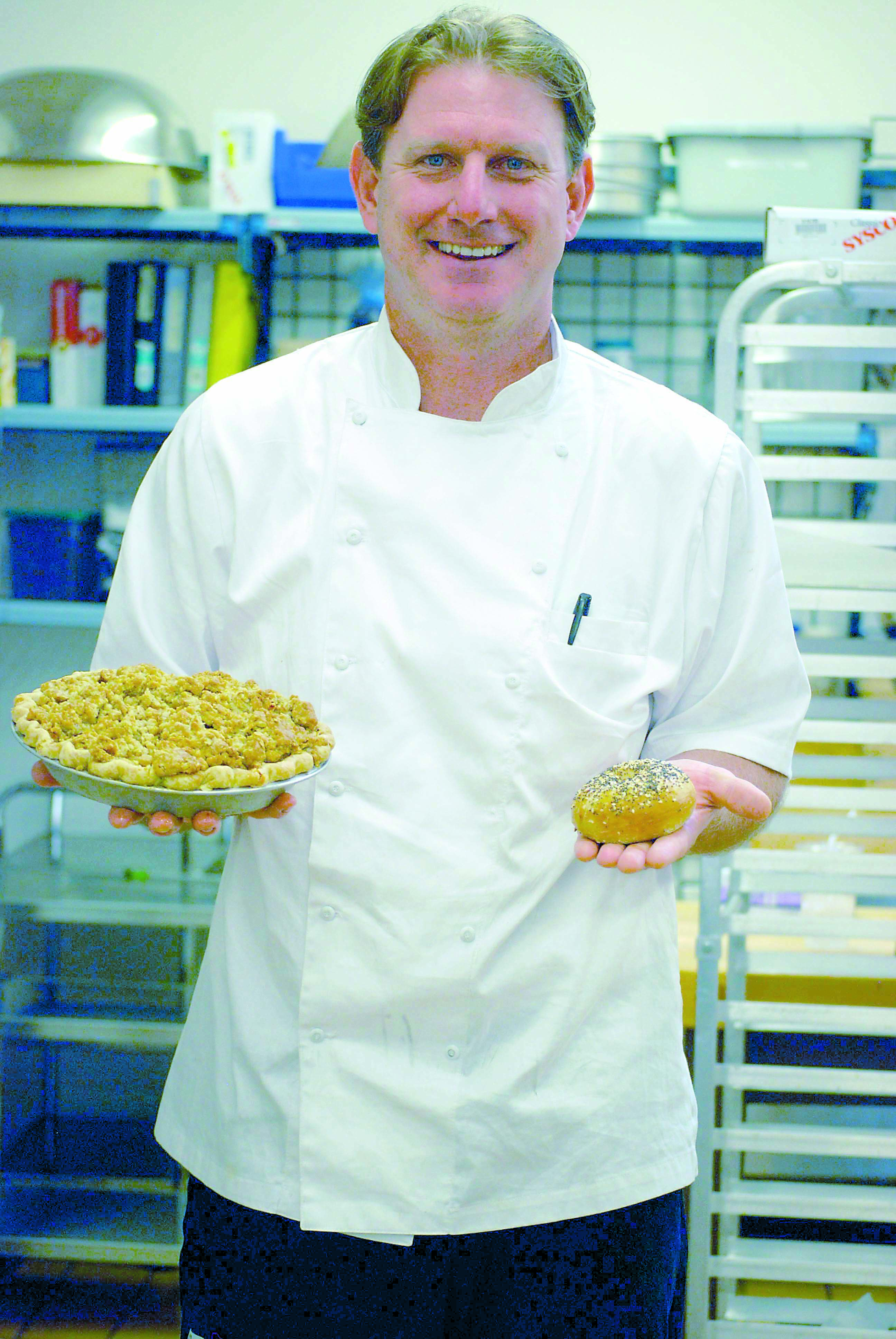 Arran Stark proudly displays local baked goods: an apple pie by pastry chef Cyndee Nighswonger and a bagel from Bob's Bagels of Port Townsend. Diane Urbani de la Paz/Peninsula Daily News