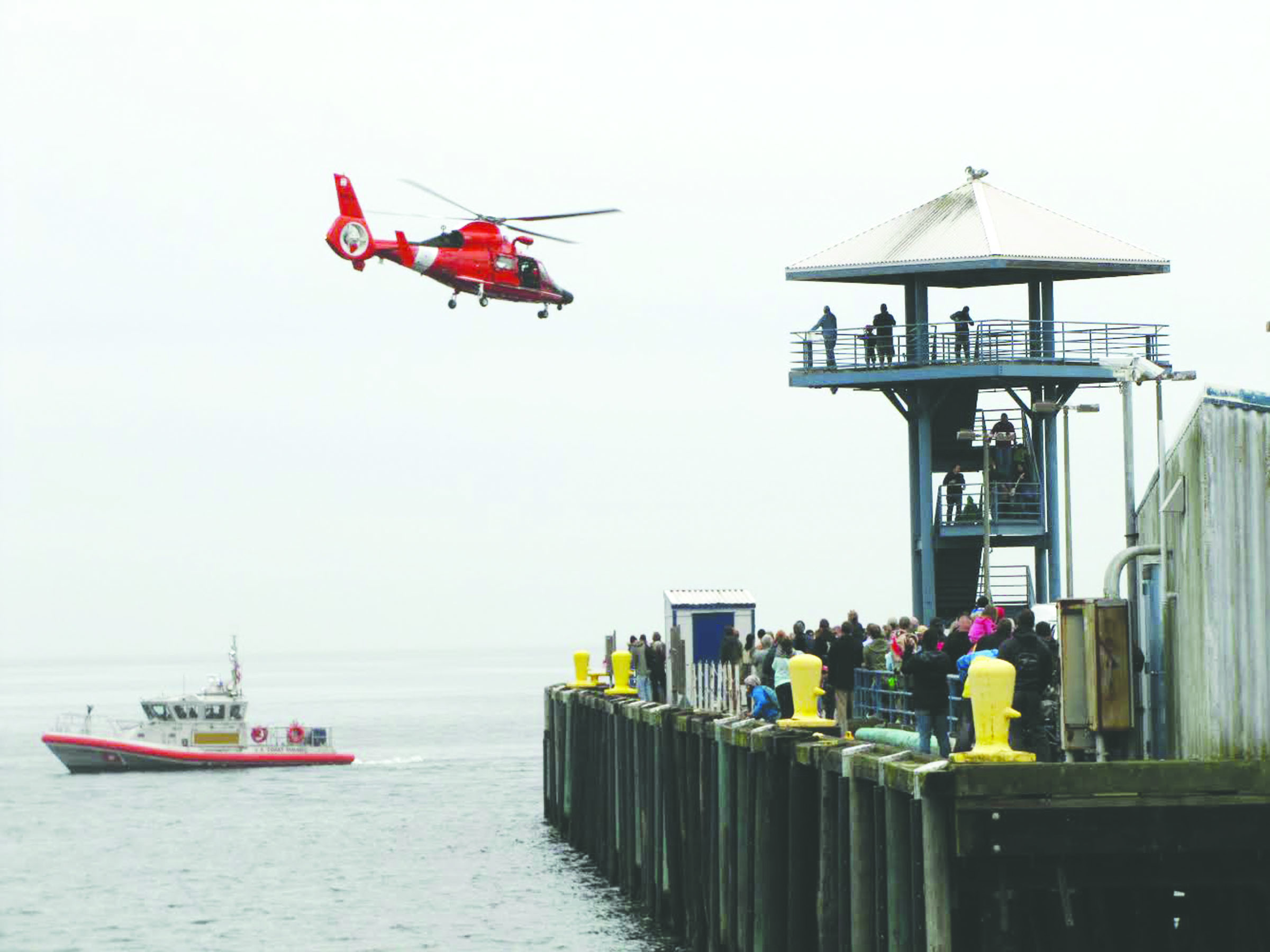The U.S. Coast Guard performs rescue demonstrations for visitors at the Dungeness Crab & Seafood Festival on Sunday off City Pier in Port Angeles. Arwyn Rice/Peninsula Daily News
