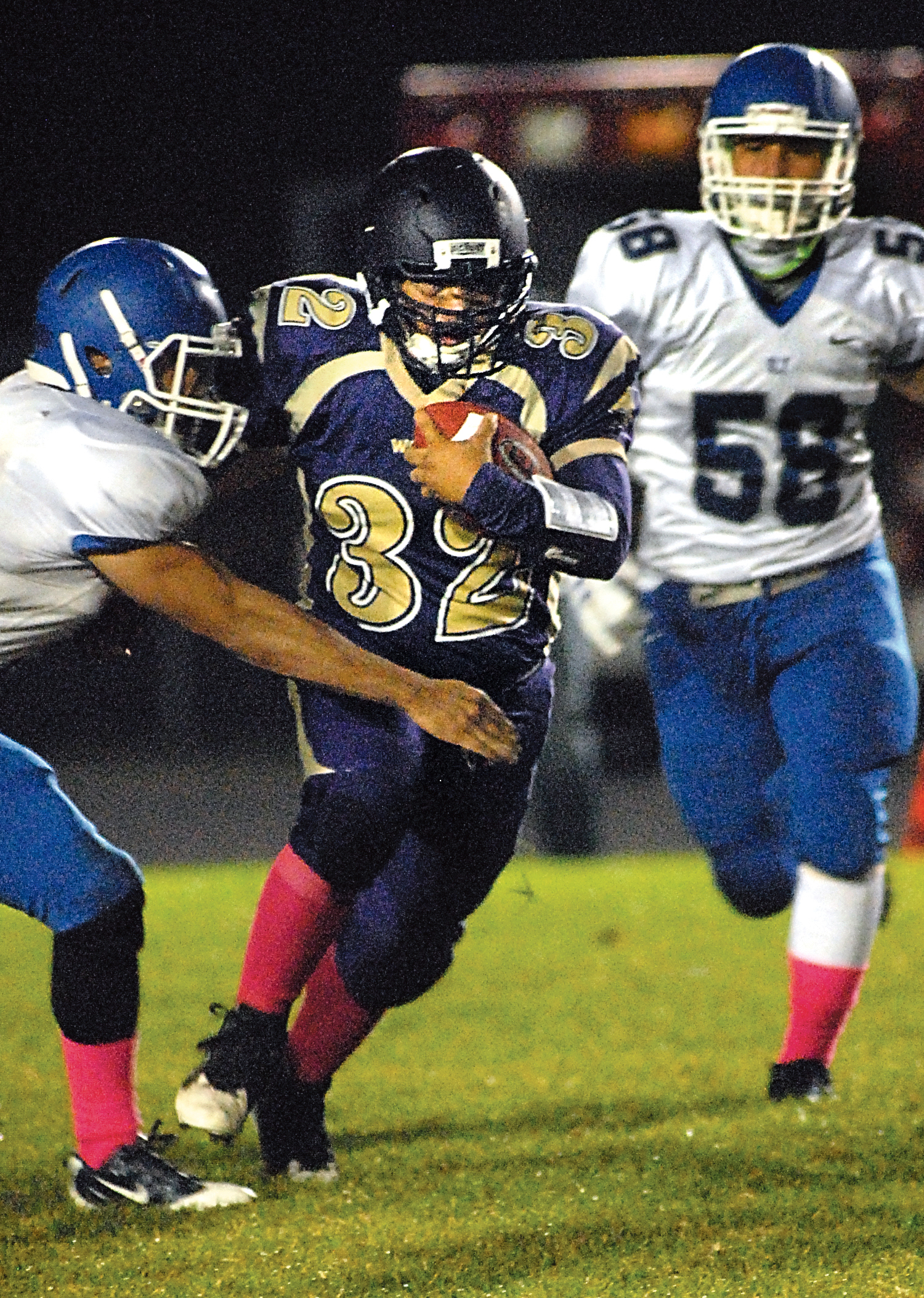 Sequim's Arnold Black (32) tries to elude Olympic's Logan Madison