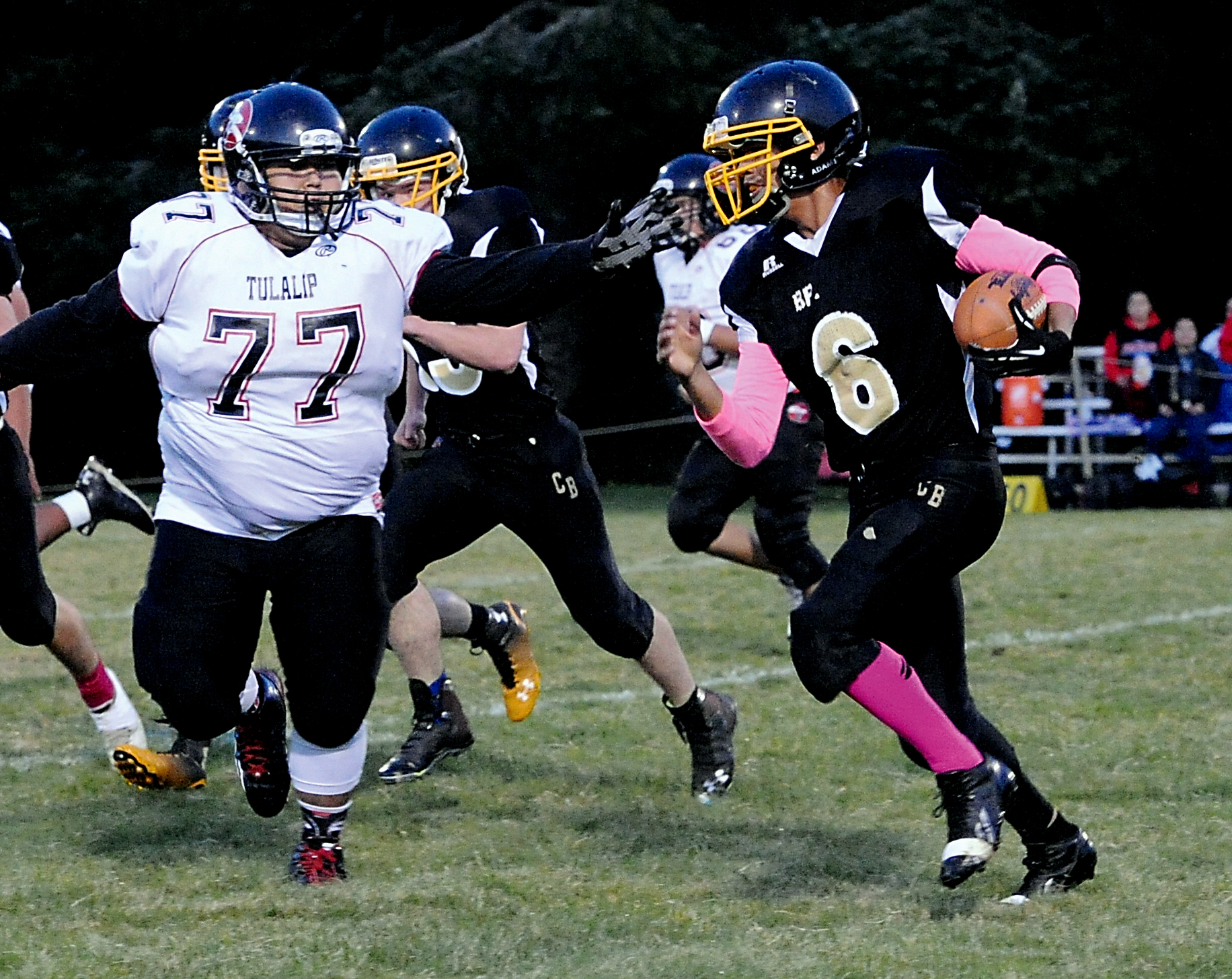 Clallam Bay's Alan Greene attempts to avoid Tulalip's Nate Williams (77) while returning an interception. Lonnie Archibald/for Peninsula Daily News