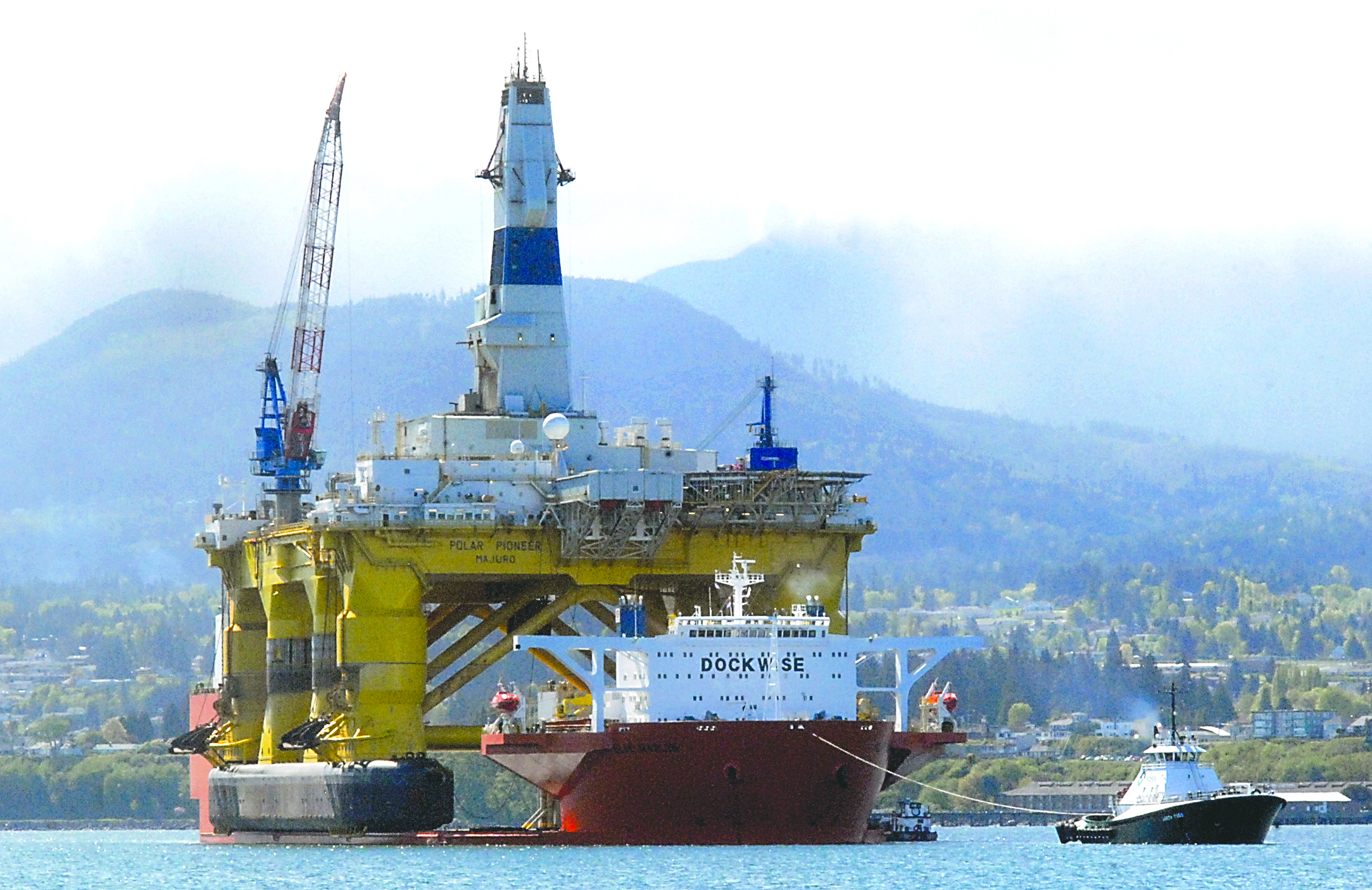 The offshore oil platform Polar Pioneer waits on April 25 to be floated off the cargo deck ship Blue Marlin into Port Angeles Harbor. The tug Garth Foss