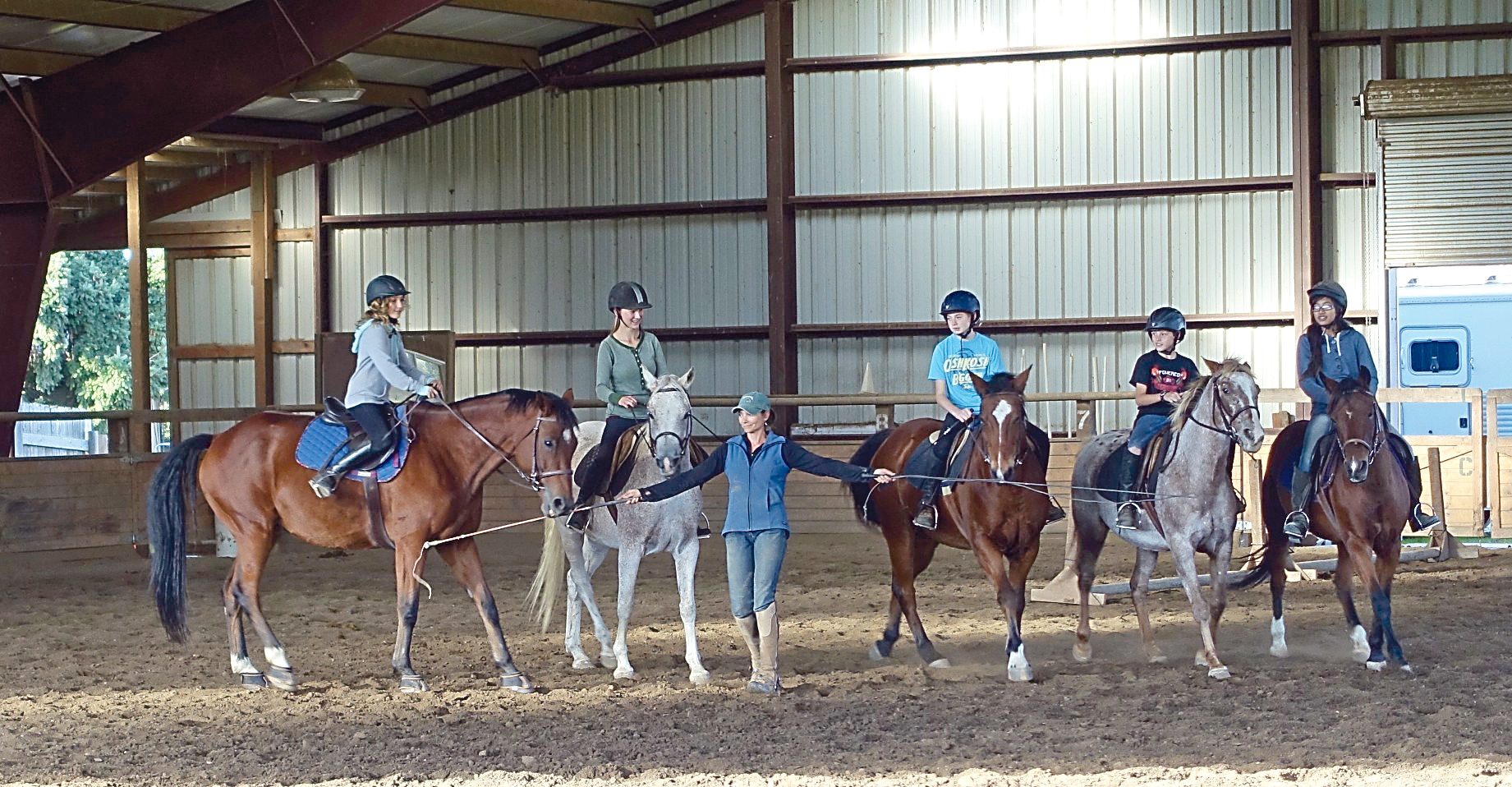 Freedom Farms instructor Jessica Crouch helps Hoof Beats Riding Club members Grace Niemeyer