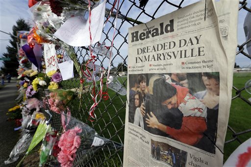 An edition of The Daily Herald of Everett with the headline “Dreaded Day in Marysville” is shown Monday as part of a growing memorial on a fence around Marysville Pilchuck High School. —Photo by Ted S. Warren/The Associated Press