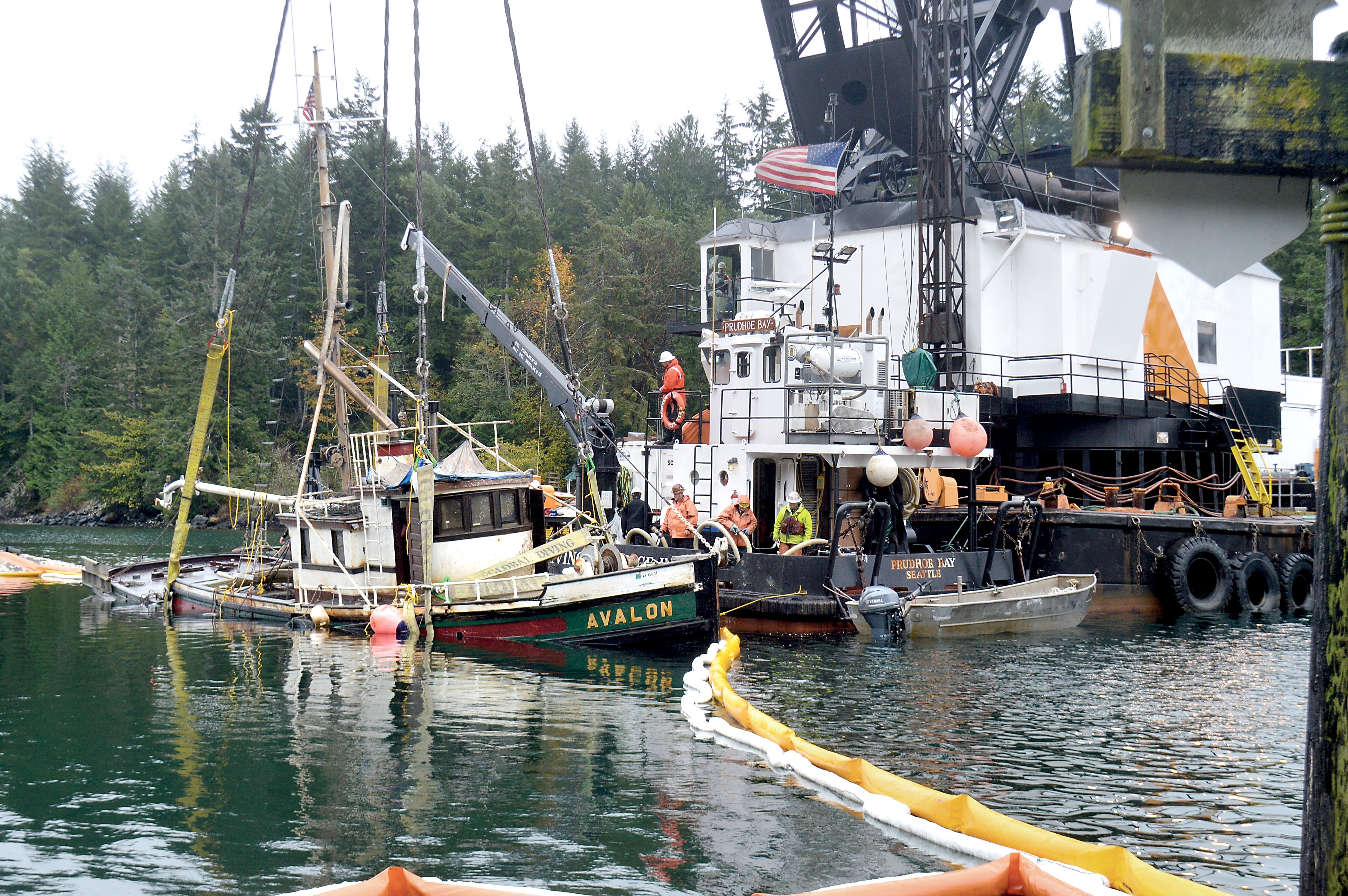 Workers with Global Diving & Salvage pull the 65-foot pleasure craft Avalon out of Pleasant Harbor in Brinnon on Tuesday. State Department of Natural Resources