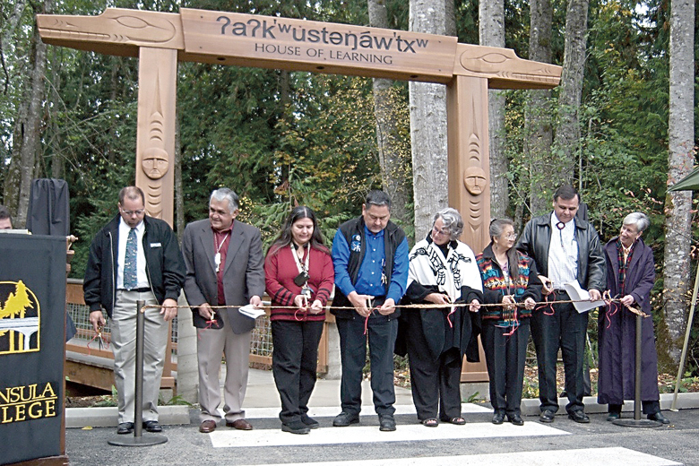 Cutting the cedar-bark ribbon to open the Peninsula College Longhouse in 2007 are