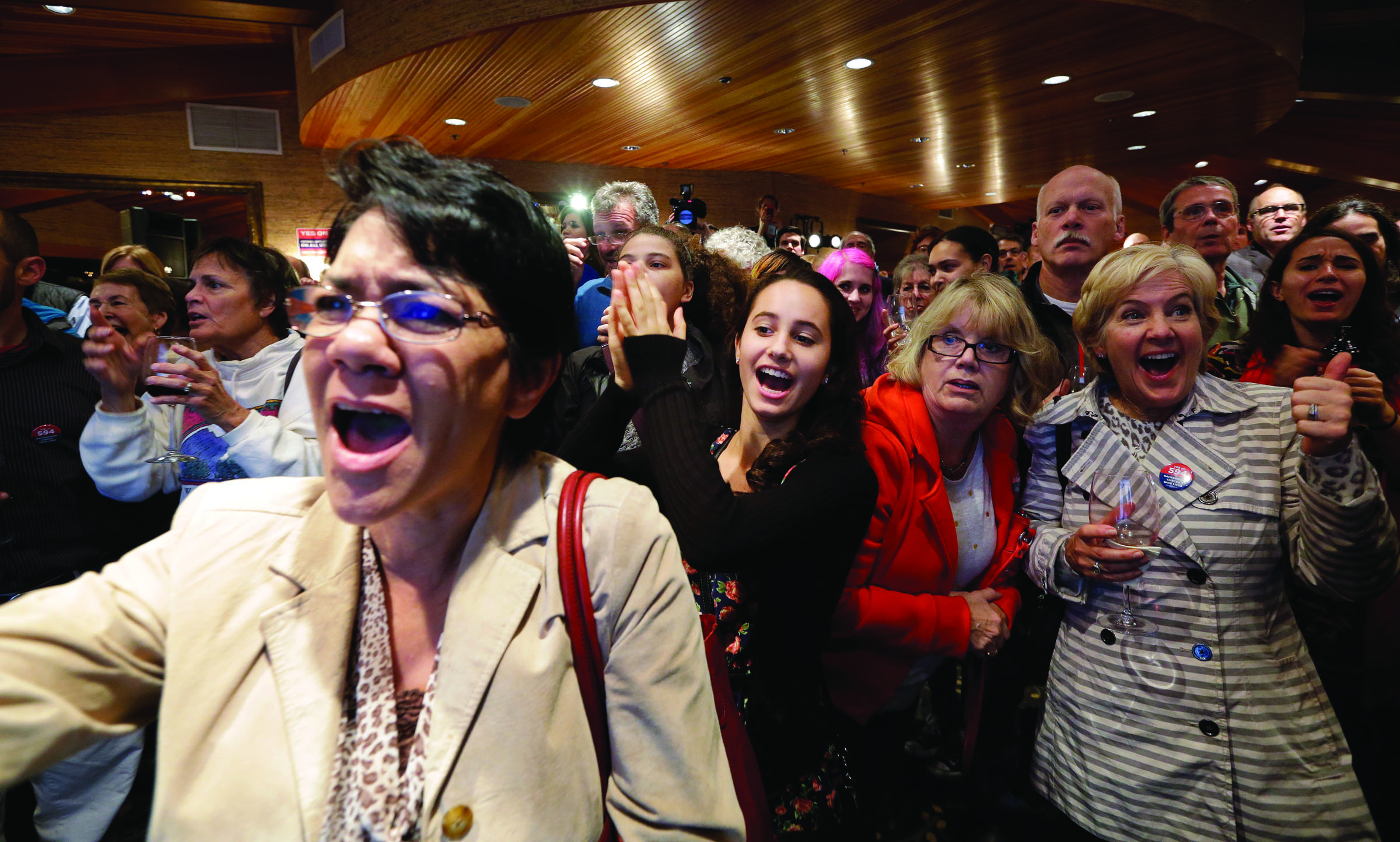 Supporters cheer as results come in at an election night party for Initiative 594