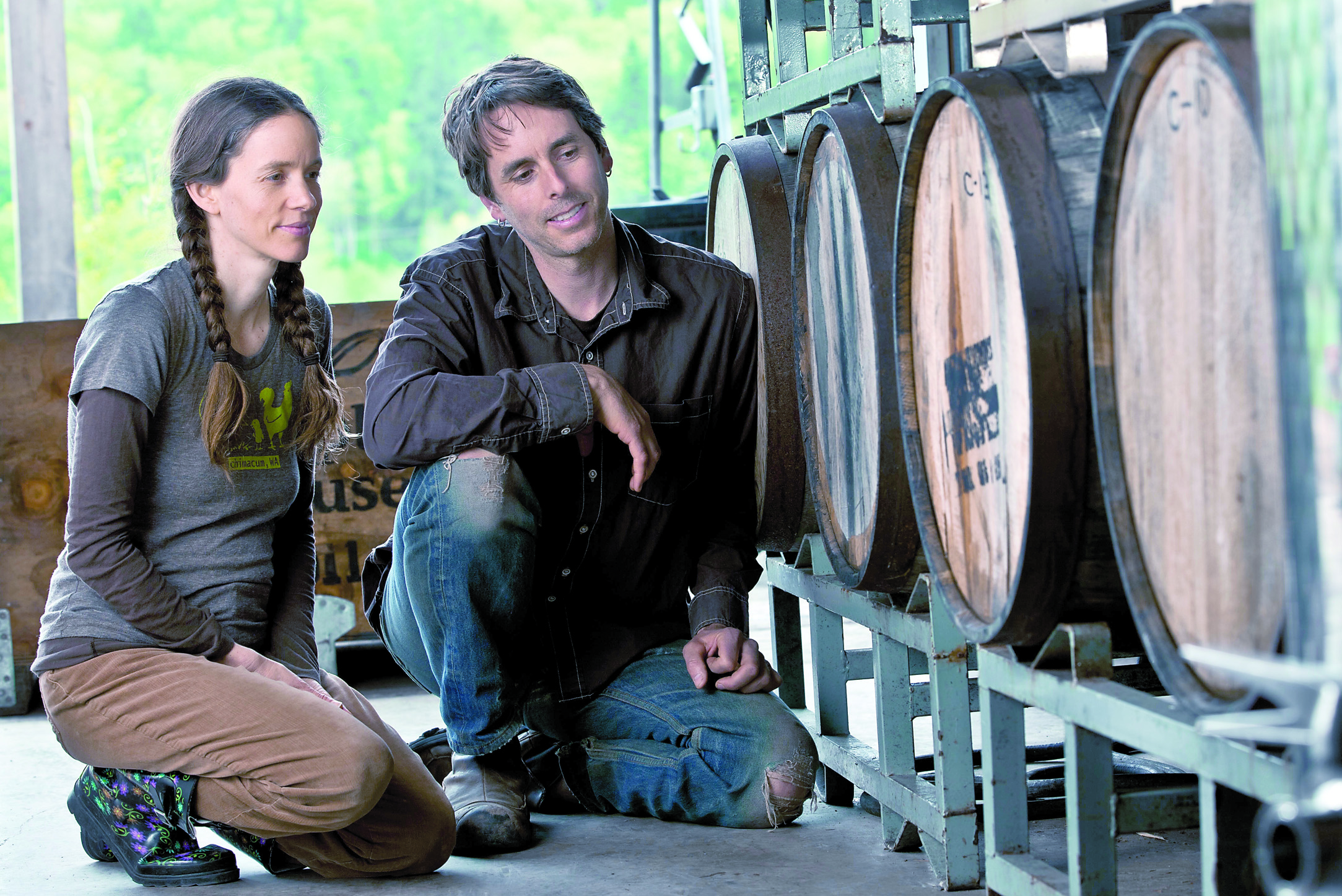 Crystie and Keith Kisler hunker beside the barrels at their Finnriver Farm & Cidery in Chimacum